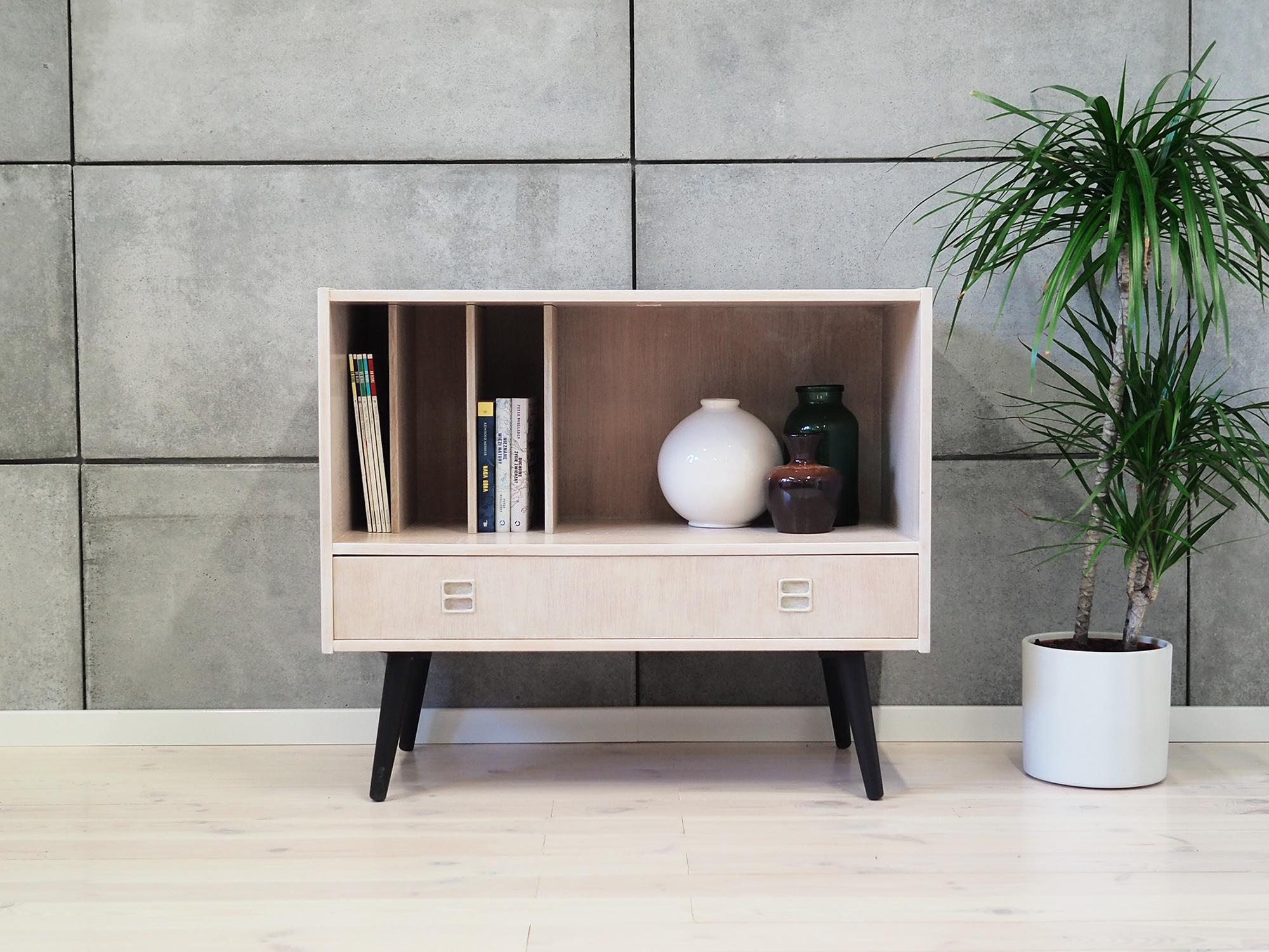 Cabinet made in the 1960s, Swedish production.

The construction is covered with whitened ash veneer. Legs made of solid wood painted black. The surface after refreshing. Inside the space was filled with practical adjustable vertical shelves. The