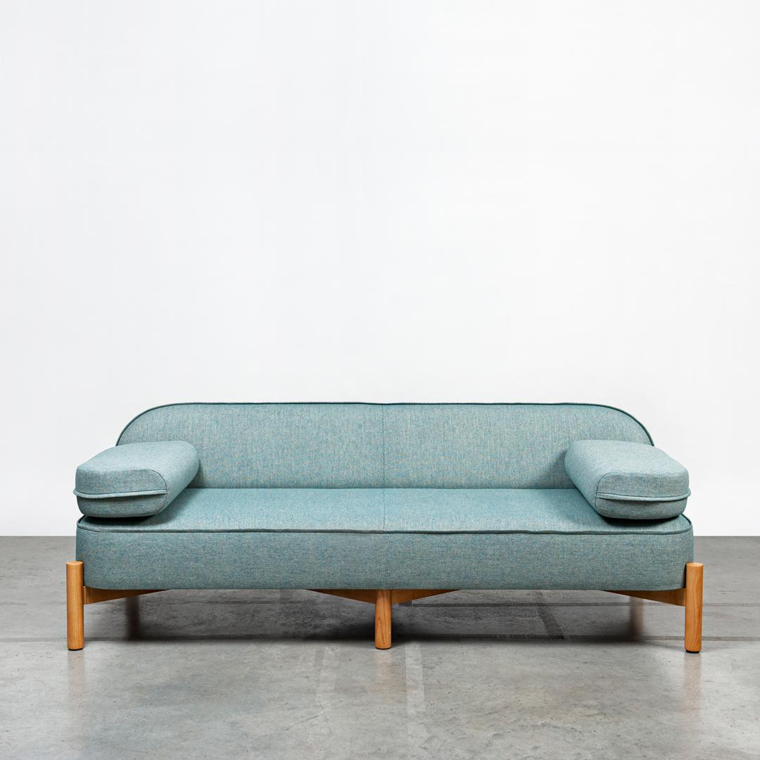 RUA CHA Sofa by Clementine Caurier
Dimensions: D 95 x W 200 x H 74 cm.
Materials: Ash, wool, and linen.

RUA CHA sofa is based on a light, crossed structure in solid wood.
The generous curves are first padded with high-density memory
foam and then