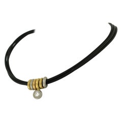 Gummi-Halsband mit dreifarbigen Goldelementen, besetzt mit einem Diamanten von 0,25 Karat