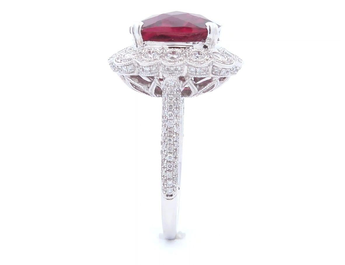 Luxury, at the right price

This unique ring has a total carat weight of 10.26 carats. The center stone is a rubelite cushion cut weighing 7.84 carats. Surrounding the rubelite are 1.64 carats of round cut diamonds set in 18K white gold.

The ring
