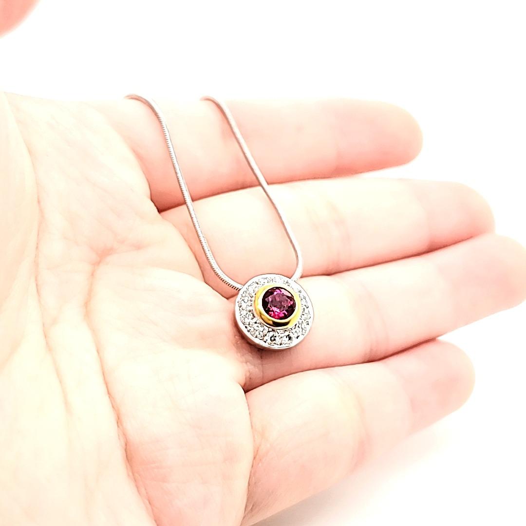 Rubelite Round Pendant in 18 K gold chain

Many a times, it is simplicity that draws attention and this is what this pendant displays : a touch of class, a strikingly beautiful face and yet is still totally unassuming.

Worn in the day, it sparkles