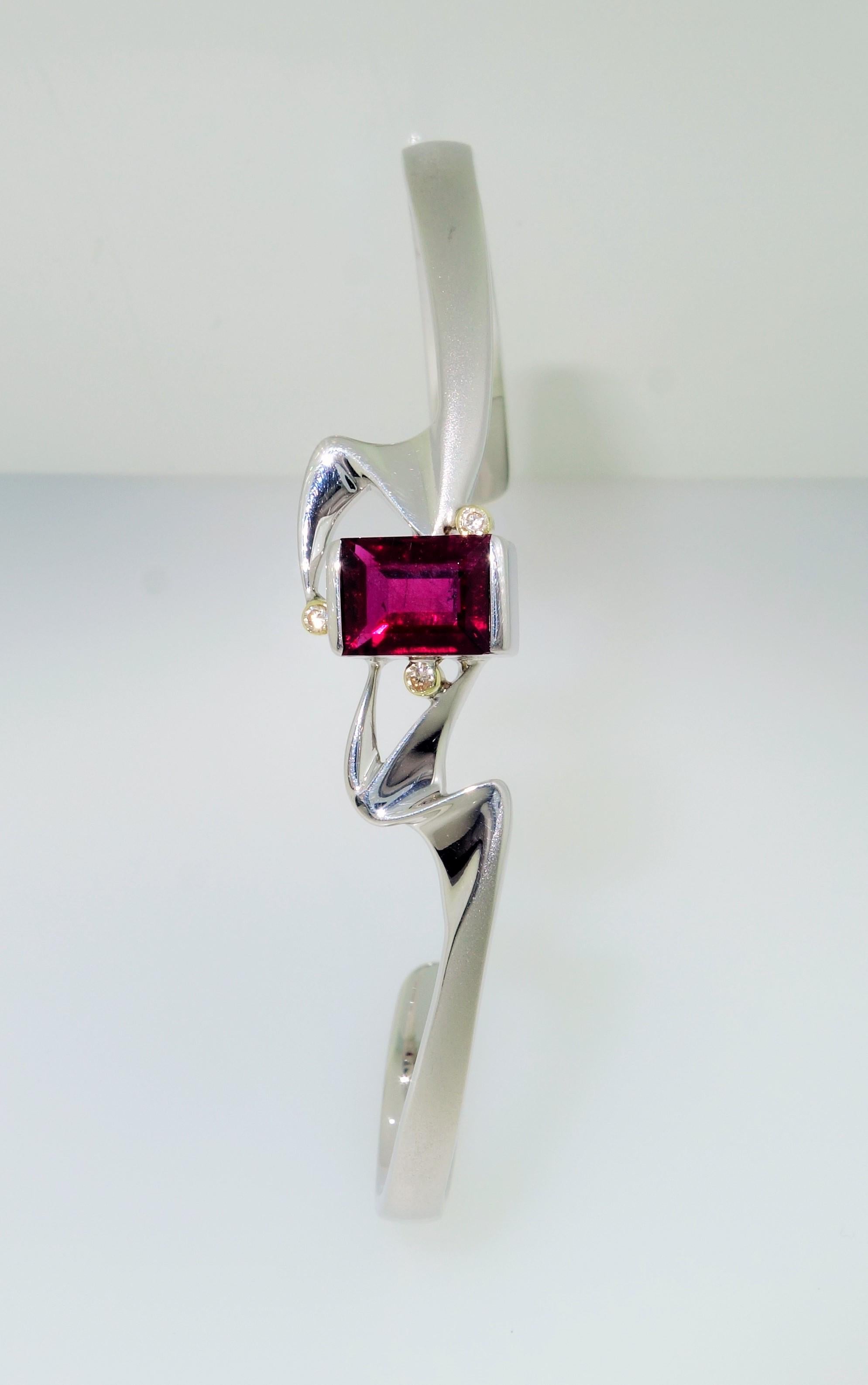 Simply Beautiful, Elegant and finely detailed Bracelet, securely nestled with a 2.50 Carat rectangular Rubelite Tourmaline, measuring 7.5mm x 7.1 mm and accented by 3 Diamonds. Bracelet size: 75mm x 55mm. Hand crafted in Rhodium sterling silver and