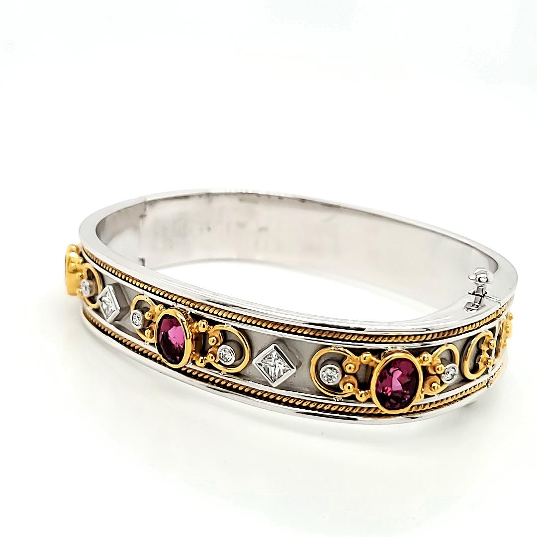 Adorn your wrist with the harmonious blend of elegance and luxury of the Rubelite Tourmaline and Diamond Bangle Bracelet.

This captivating bracelet features three oval Rubellite tourmalines, totaling 2.70 carats.

Set in warm yellow gold bezels,