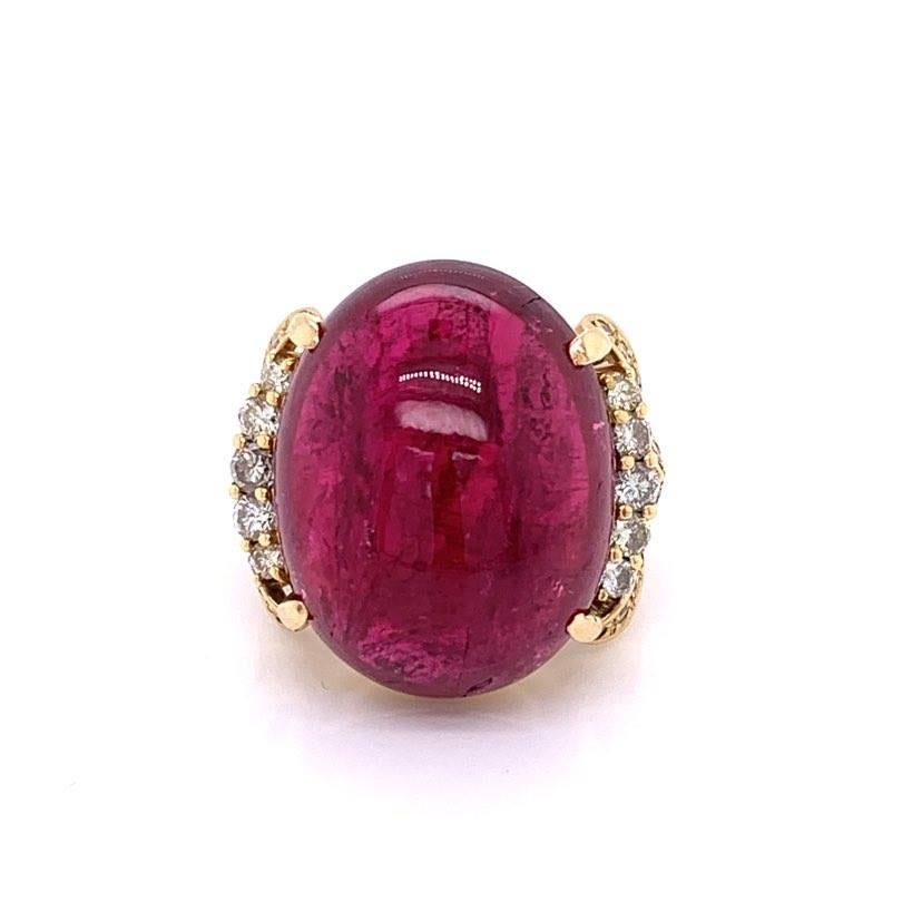 An intense red tourmaline cut as a cabochon, this stone weights 30.50 carats. The tourmaline’s mesmerizing vivid red color is accented by 0.71 carats of round cut diamonds. Set in 18K yellow gold, this cocktail ring is truly a special piece you will