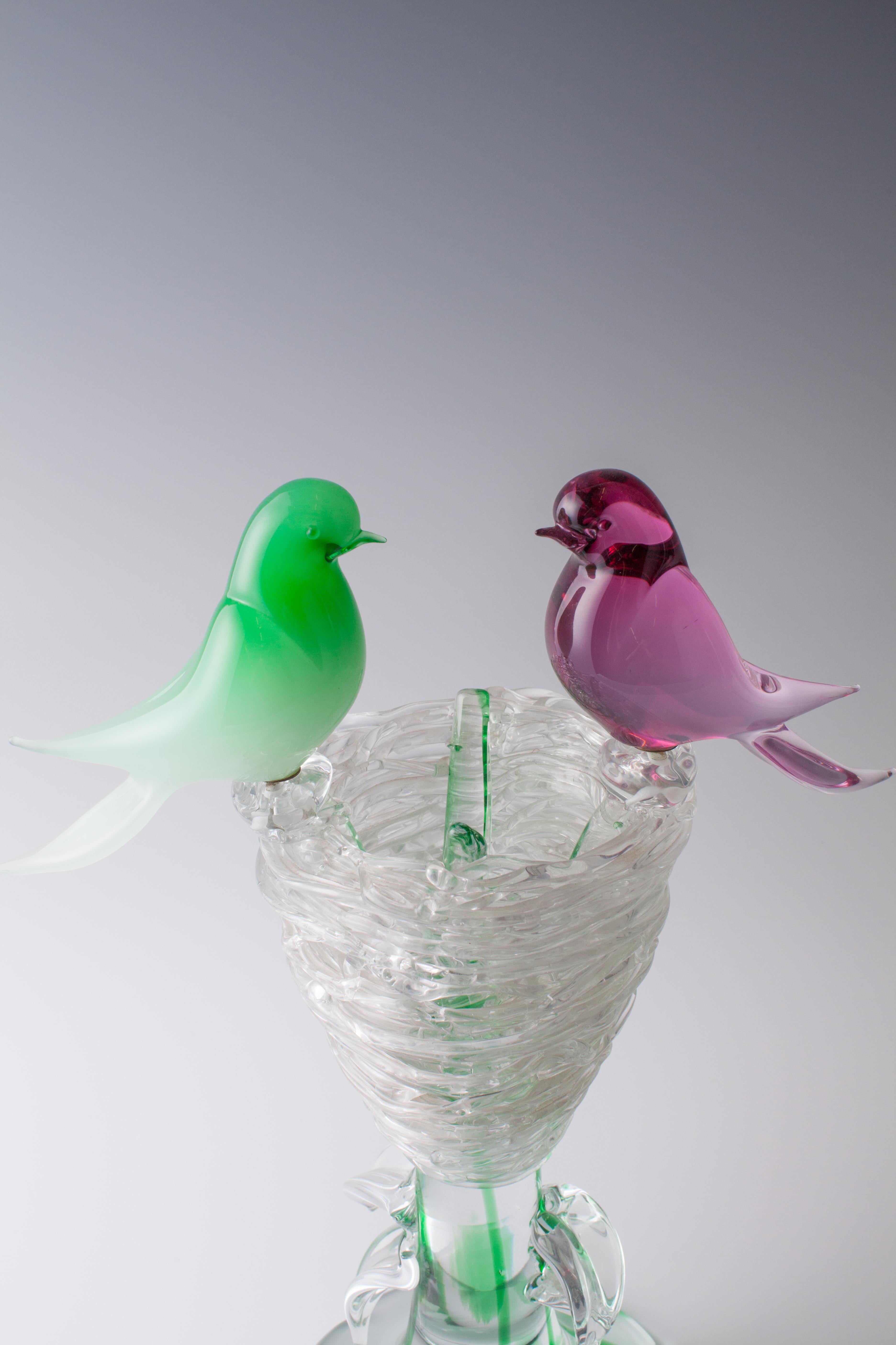 Very elaborately crafted Rubelli Murano glass object.
Tree trunk with a bird's nest and two birds. The tree trunk of colorless glass with green glass fuse seals. The nest of colorless glass, which was formed very complex and with attention to