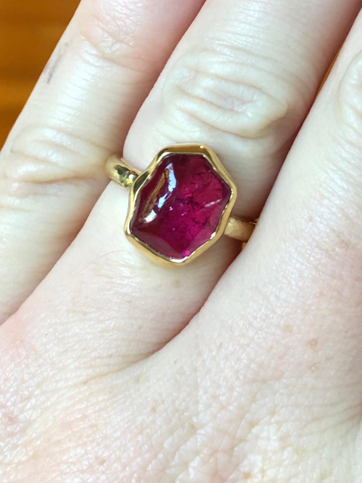 Performs miraculously in every light with incredible depth of color. German cut baroque African rubellite in our hand fabricated 100% recycled gold 18 karat setting. Part of our baroque gem collection. Polished bezel, hand hammered shank.

Fine