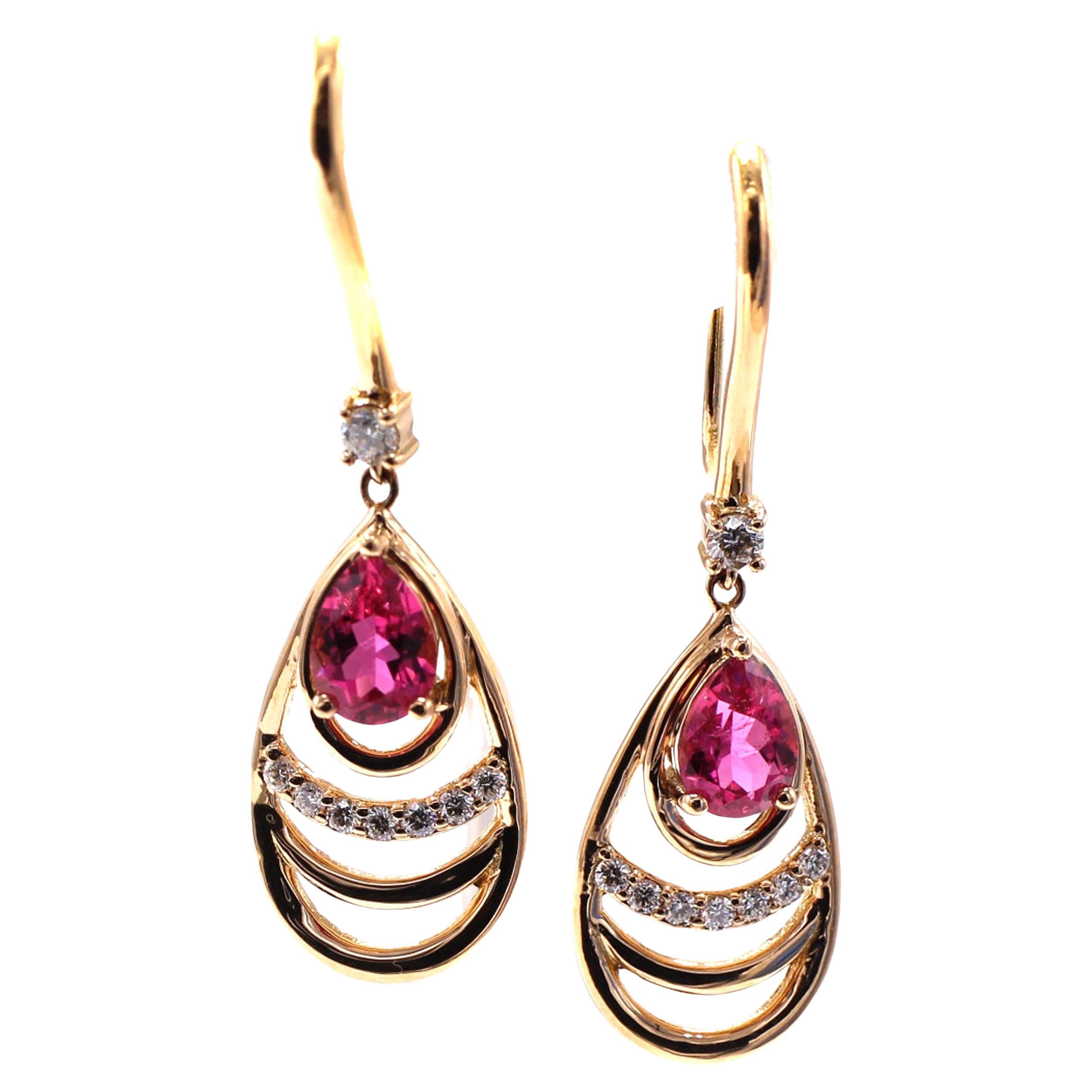 These beautifully designed and masterfully handcrafted earrings are both a chic and contemporary every-day wear. 2 perfectly matched bright and lively pinkish-red rubellites are set at the top of the teardrop mounting and a band of bright white and