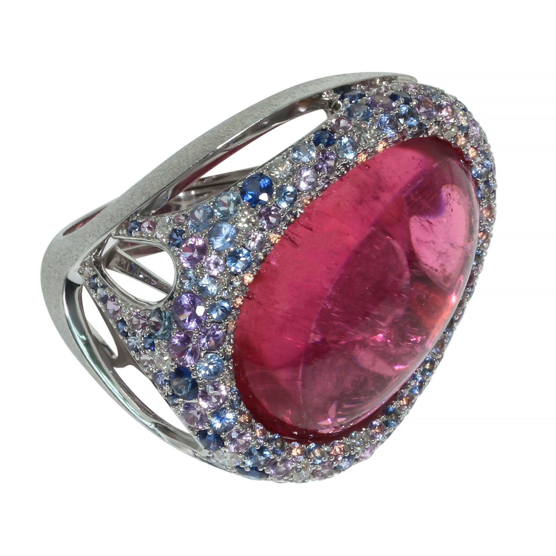 Rubellite 22.86 Carat Diamonds Sapphires 18 Karat White Gold Ring

Combination of Purple and Blue sapphires and Diamonds perfectly highlight the rich pink color of 22.86 Carat Oval Cabochon cut Rubellite. As you can see the Ring is made in an
