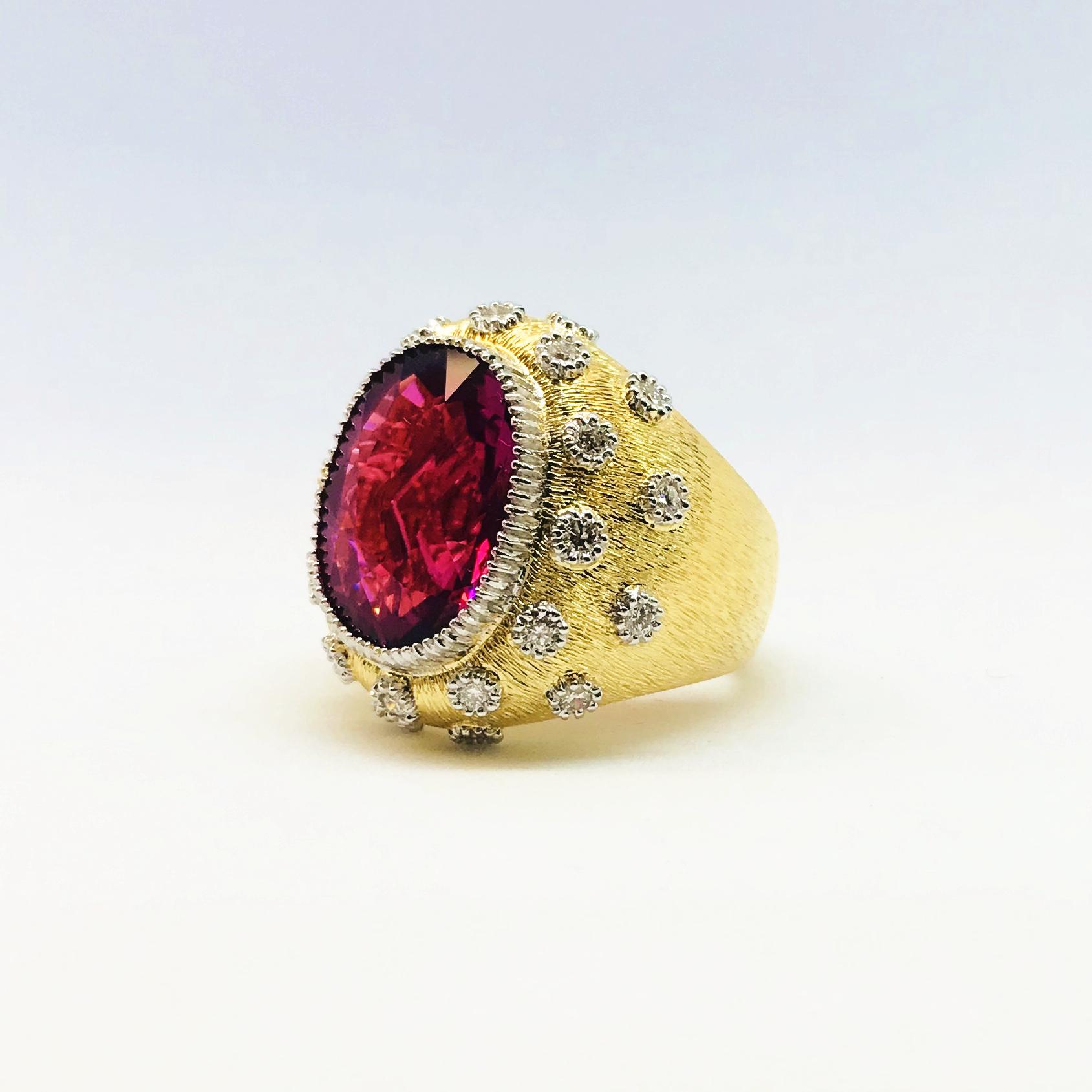 One Rubellite and Diamond yellow and white gold domed shaped ring centering one oval-shaped rubellite weighing approximately 9.97 cts. and accented with 24 white round brilliant cut diamonds arranged around the rubellite in two spaced staggered