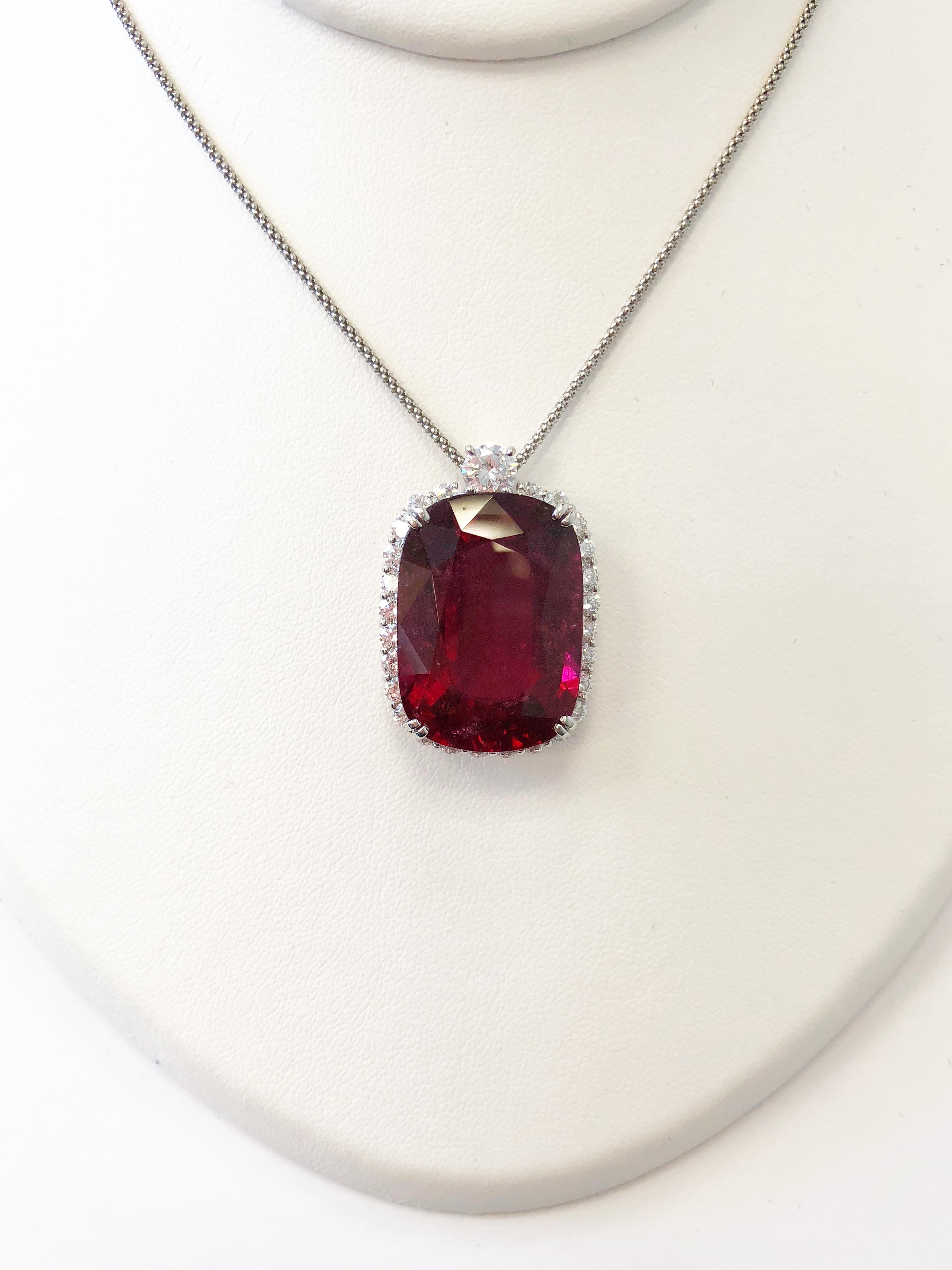 Gorgeous deep red 40.83 carat rubellite cushion surrounded by 2.57 carats of bright white clean diamond rounds in a handcrafted platinum mounting.  Length is 20