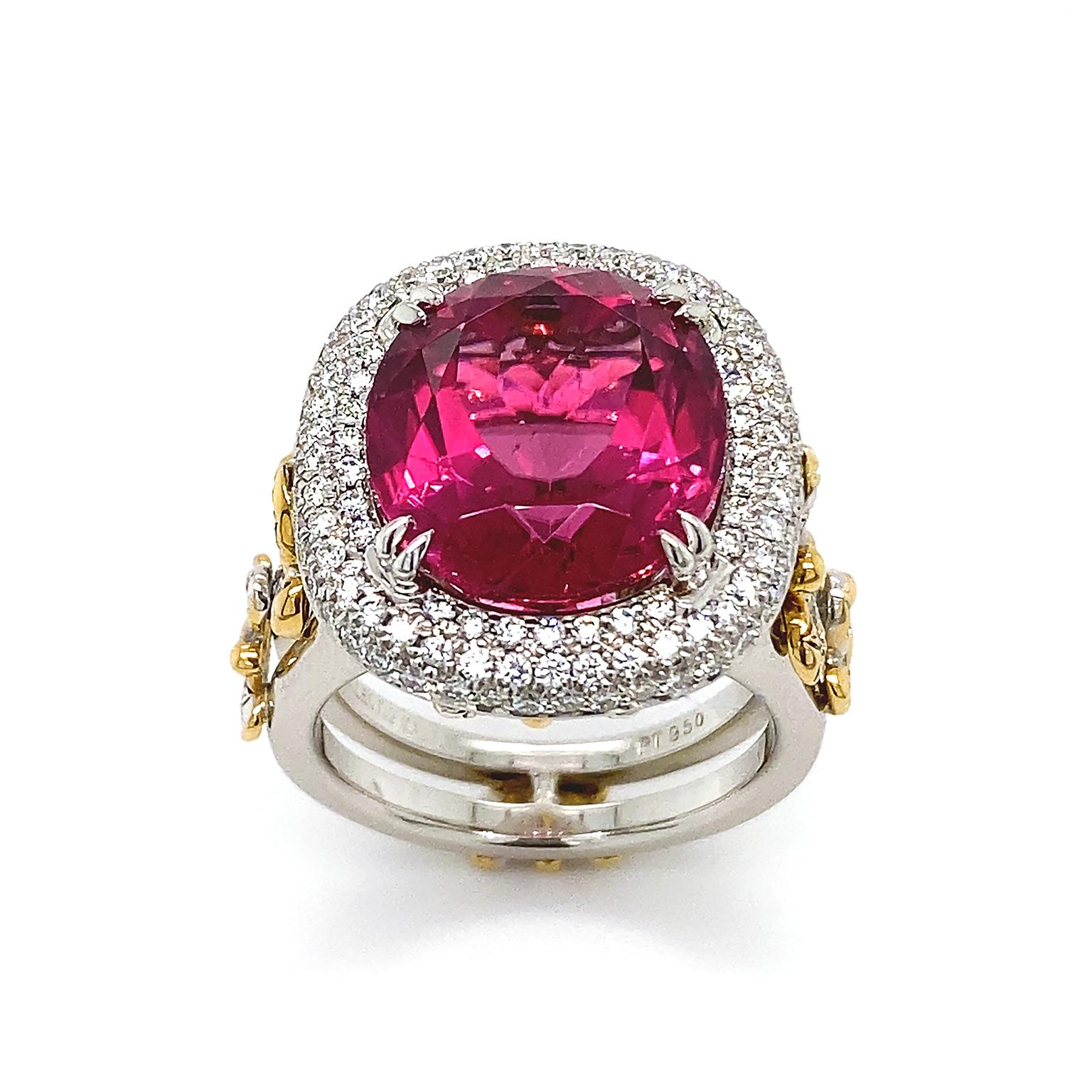 Butterflies of brilliant cut diamonds and gold frolic upward along the band of this ring. The culmination is a rubellite in a faceted cut, reflecting a brilliant smolder, secured by platinum prongs. Surrounding the jewel are three rows of micro pave