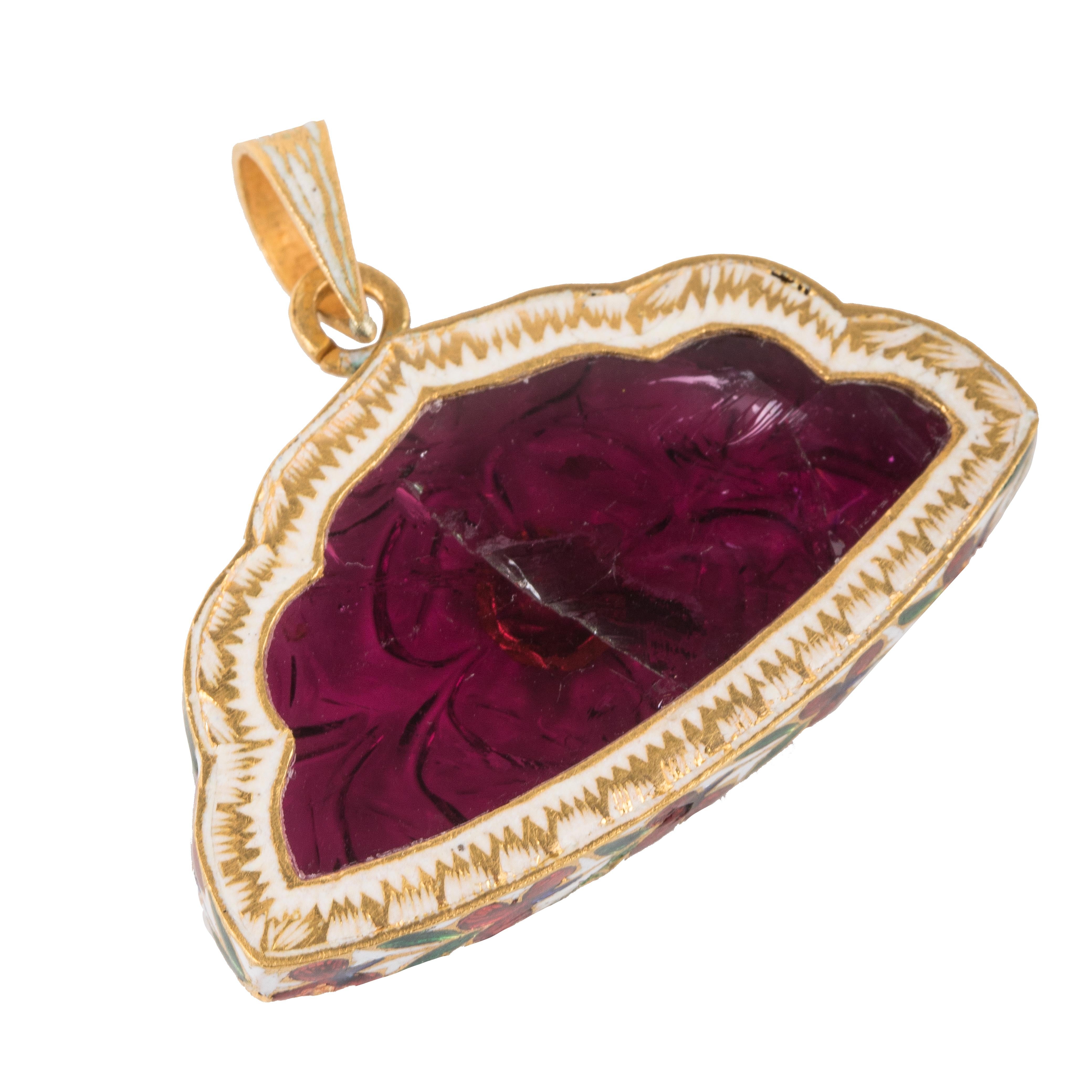 This pendant features a 40-carat Rubellite stone that has been hand-carved with flower carving. There is an uncut diamond on the front. This stone originates from Brazil and the pendant has 22carat gold enameling on the sides. 