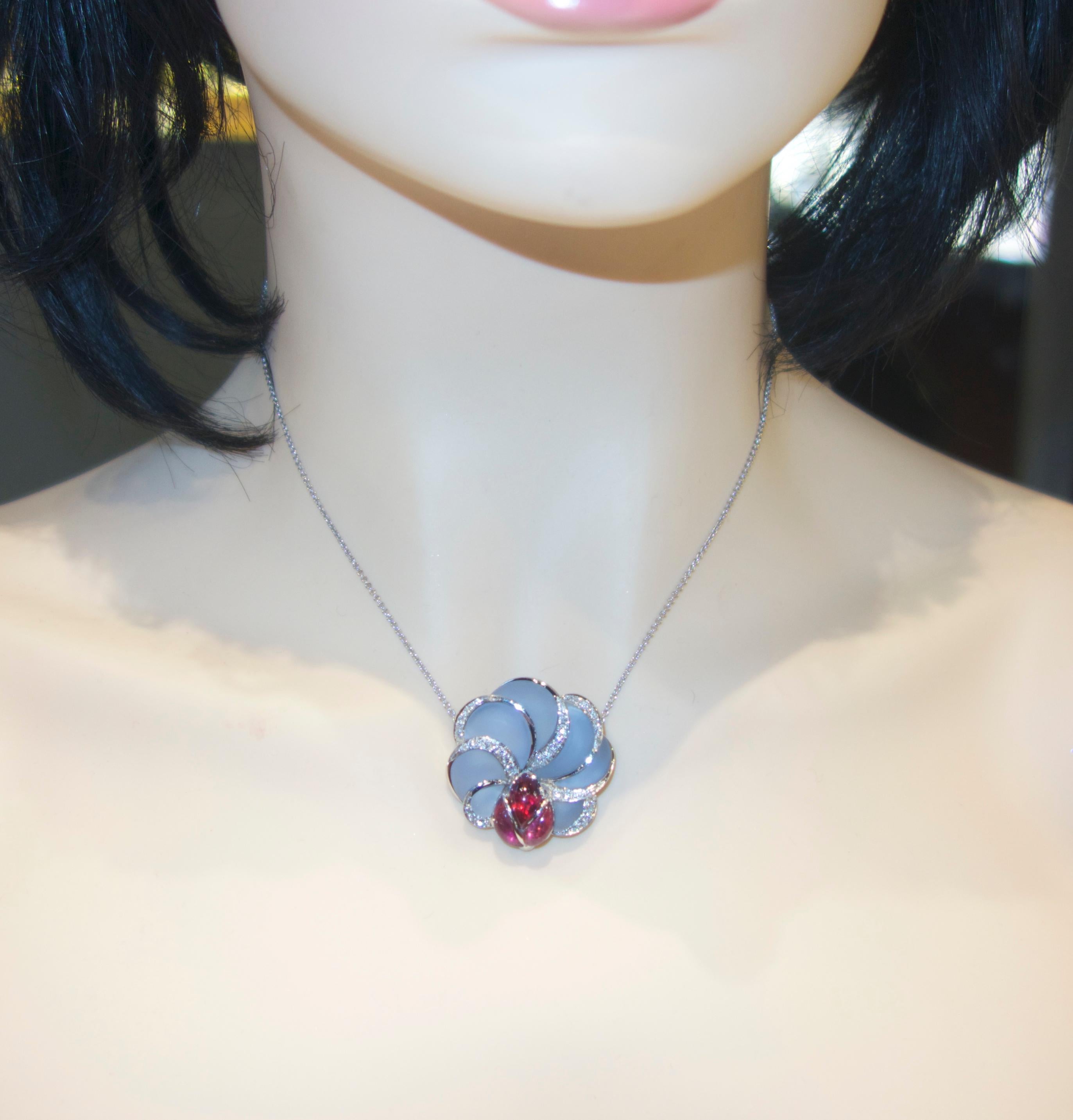 18K white gold pendant necklace prong set with natural bright red rubellite in a lady-bug motif perched on a llower made of frosted fancy cut natural light blue Chalcedony (a form of agate). and  accented with 33 diamonds - all finely cut, well