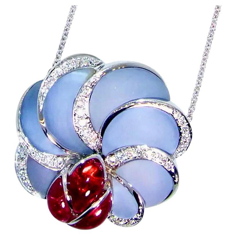 18K white gold pendant necklace prong set with natural bright red rubellite in a ladybug motif perched on a flower made of frosted fancy cut natural light blue Chalcedony (a form of agate). and  accented with 33 diamonds - all finely cut, well