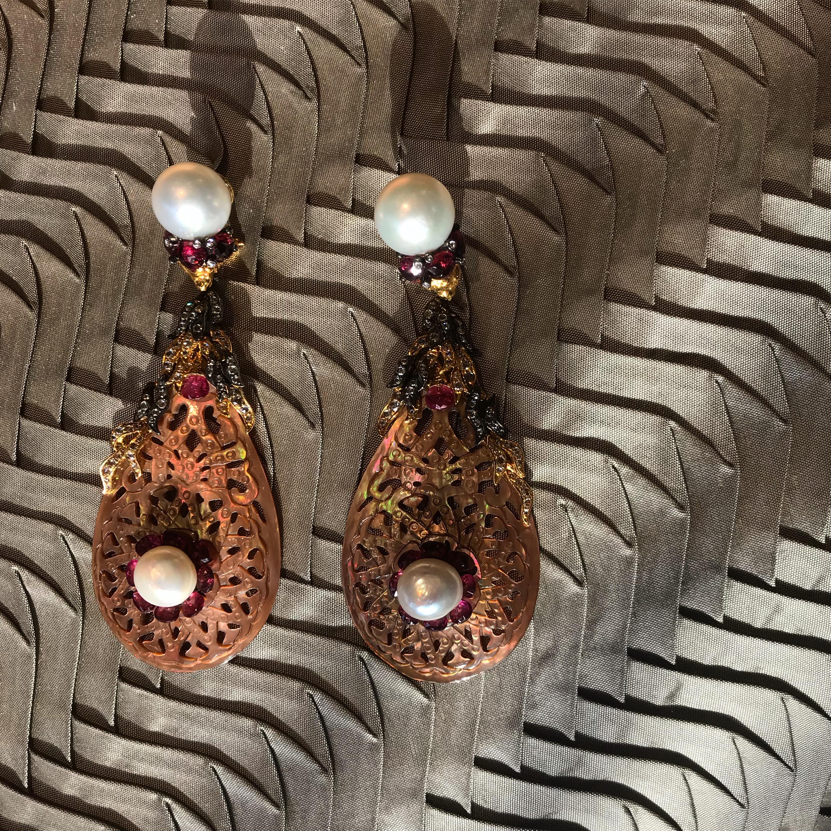 Exotic colors emanate from the mother-of-pearl nacre. These sea reef and rock creatures build the shells as they grow, with rings of colors gray, brown, blue, green, pink and gold.
These earrings have assortment of handcrafted jewelry incorporating