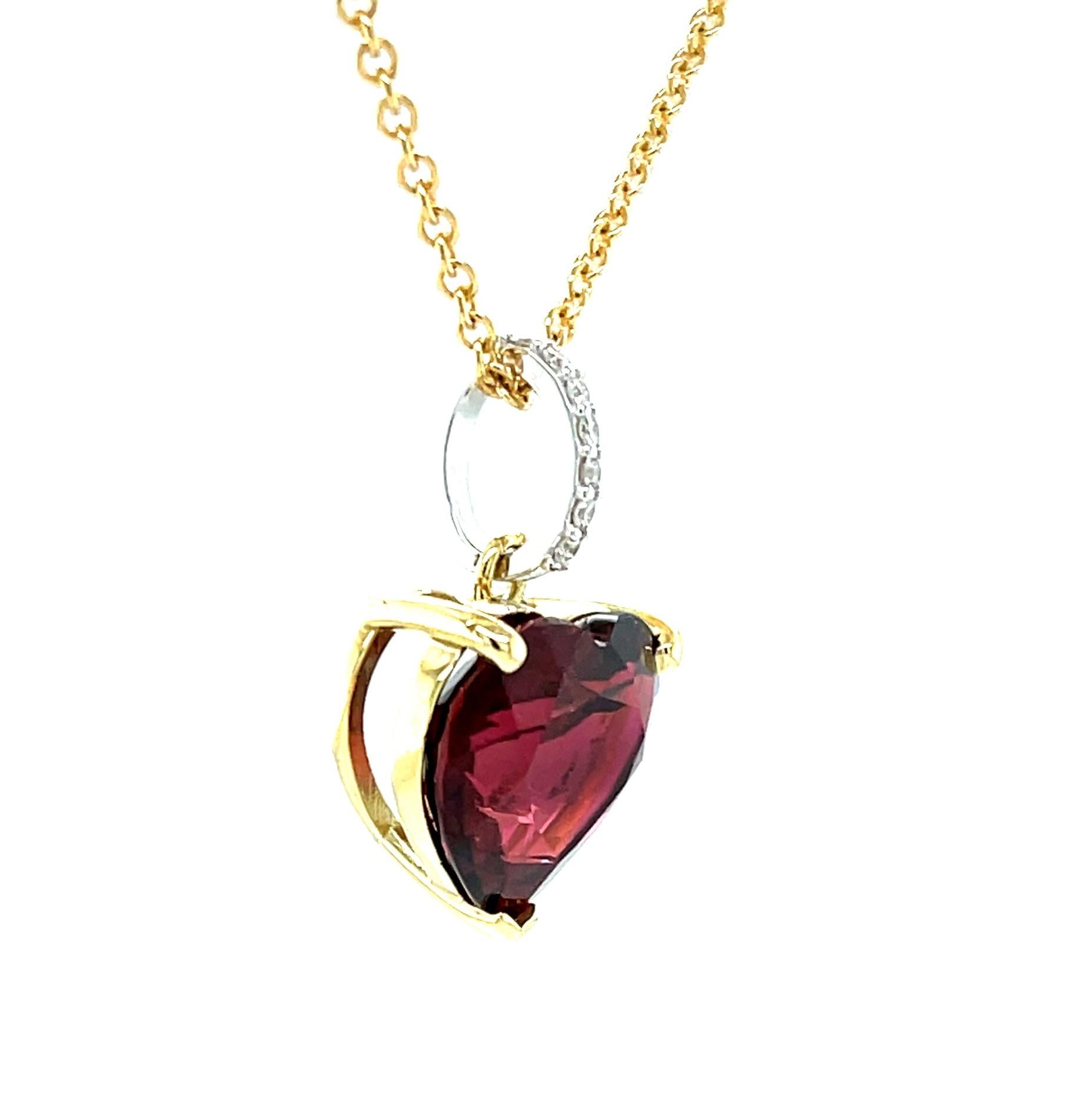 This impressive rubellite and diamond necklace features a beautiful 9.28 carat heart-shaped red tourmaline set in a handcrafted 18k yellow gold basket and a sparkling diamond-set bail! The large rubellite is a perfectly proportioned heart-shape with