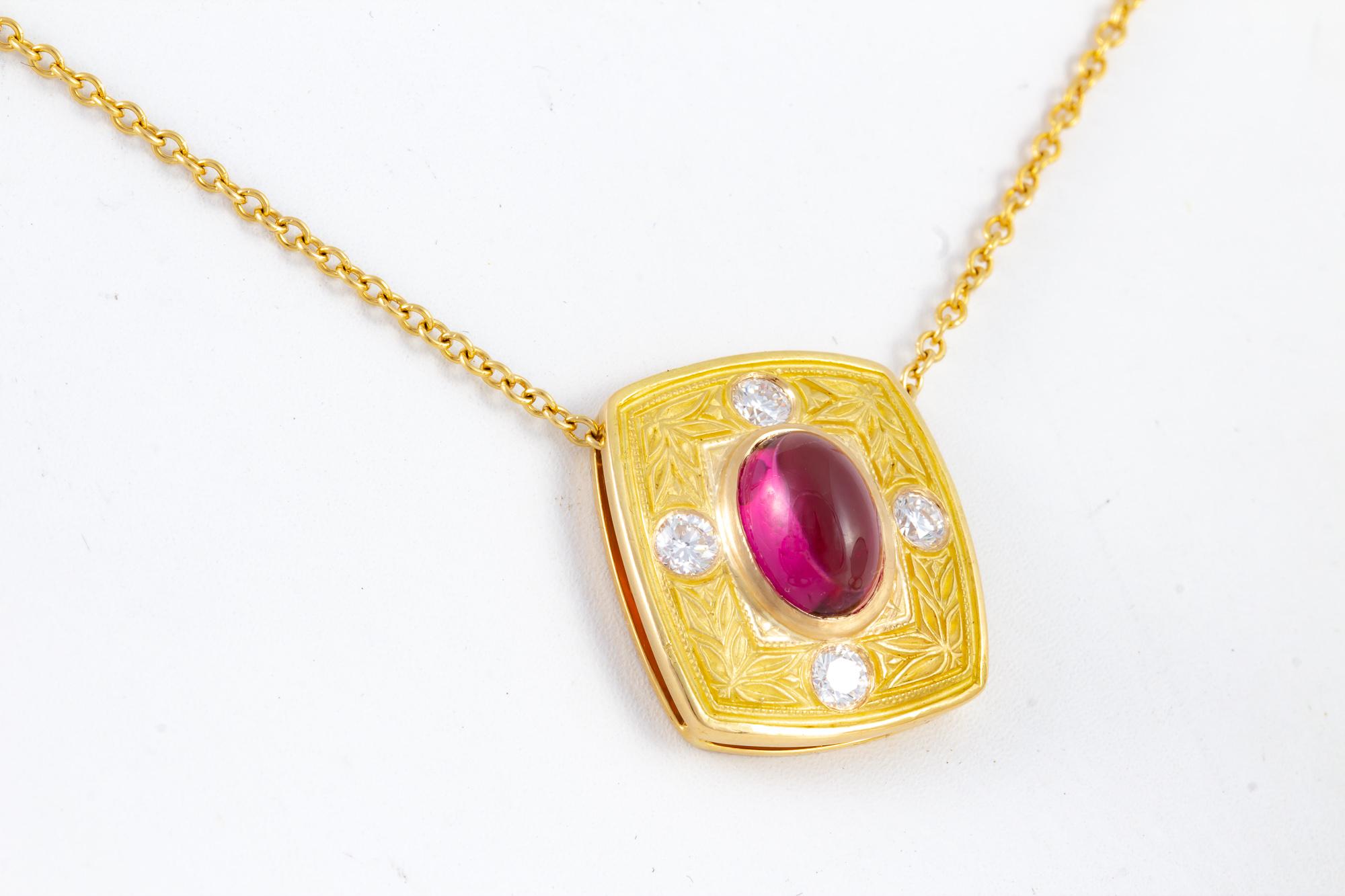 Handcrafted by a master jeweler, this exquisite Rubellite Tourmaline is set in a beautifully hand engraved setting in yellow 18 kt gold.  The center stone is 4.20 carats, surrounded by .40 carats of diamonds.  Handcrafted in the United States by a