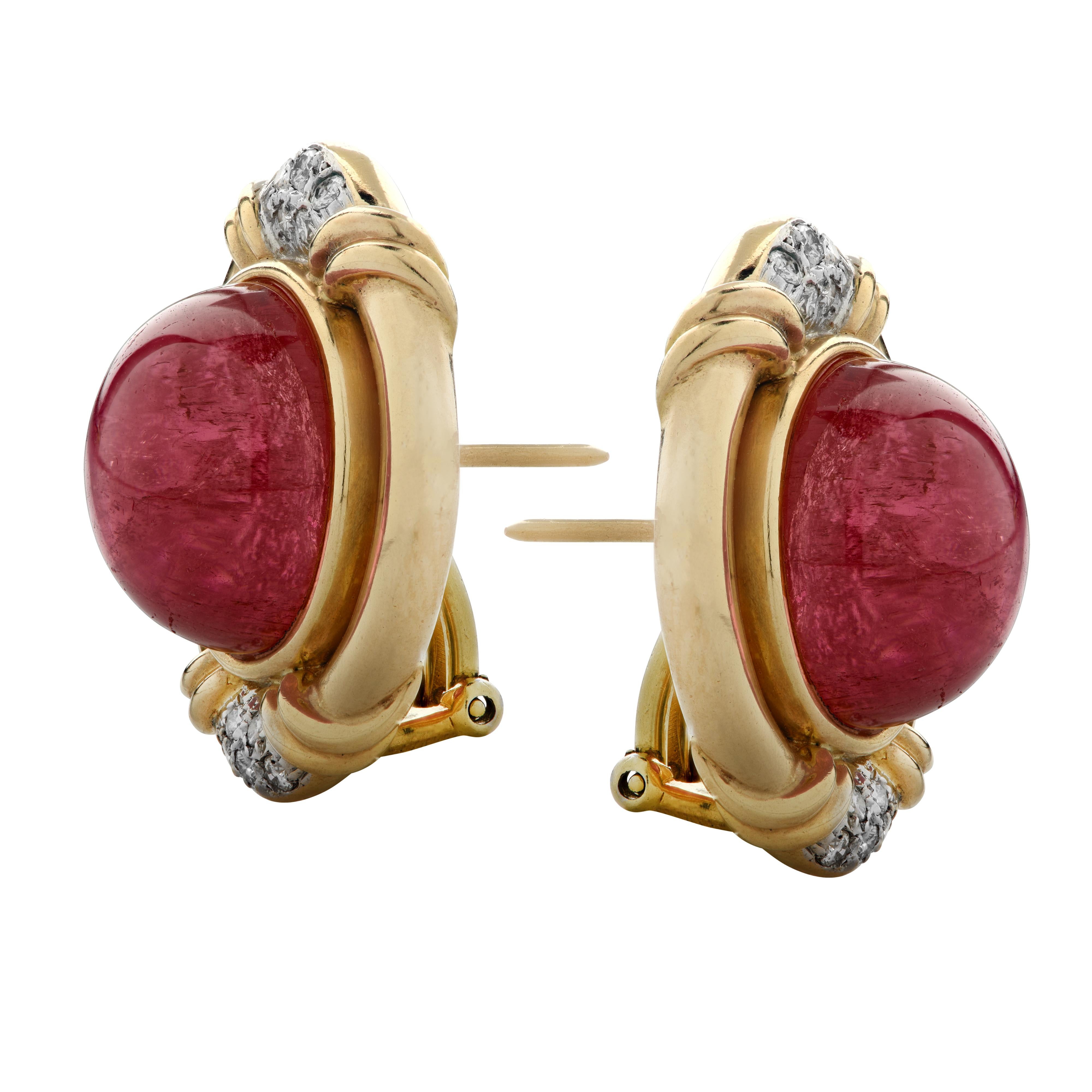 Beautiful earrings crafted in yellow and white gold showcasing two round rubellite tourmaline cabochons measuring .5 of an inch in diameter framed in yellow gold adorned with 20 round brilliant cut diamonds weighing approximately .3 carats total, G