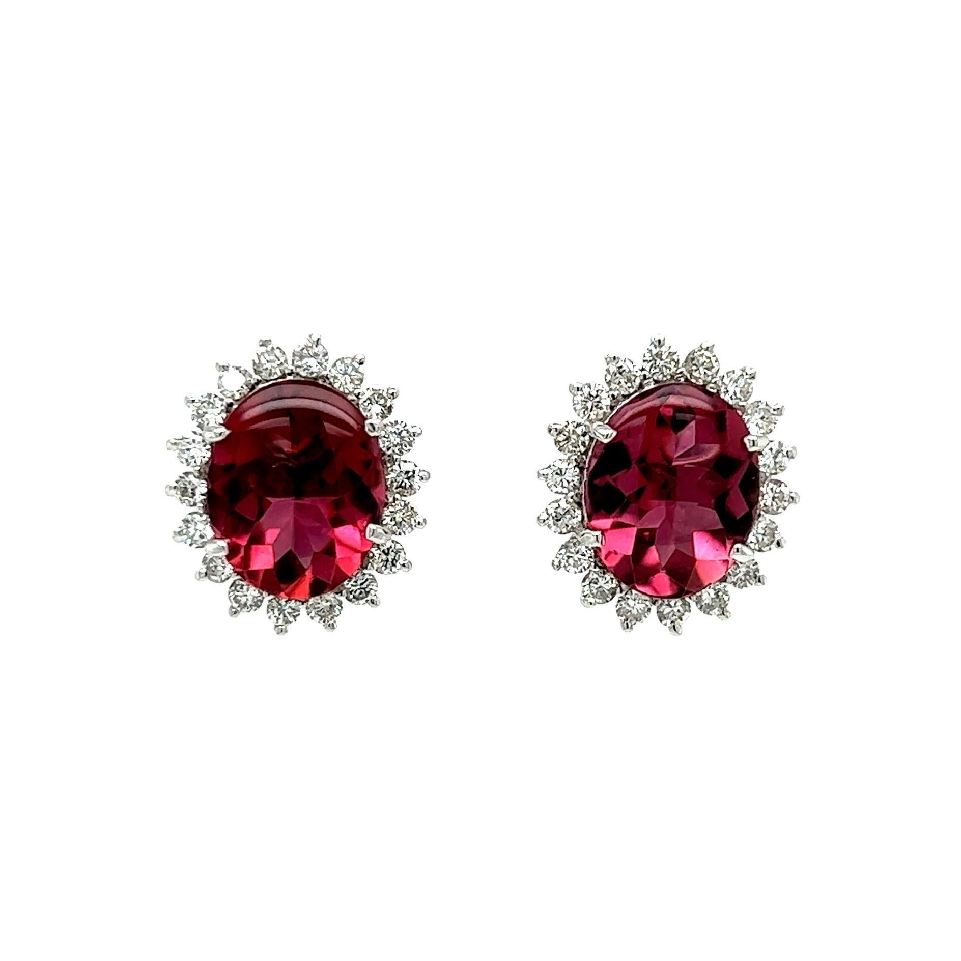 Simply Beautiful! Rubellite Tourmaline and Diamond Earrings. Each earring centering a securely nestled Hand set Oval Rubellite Tourmaline, 4.82tcw of 2 Tourmalines. Surrounded by Diamonds, approx. 0.70tcw. Approx. Dimensions: 0.67