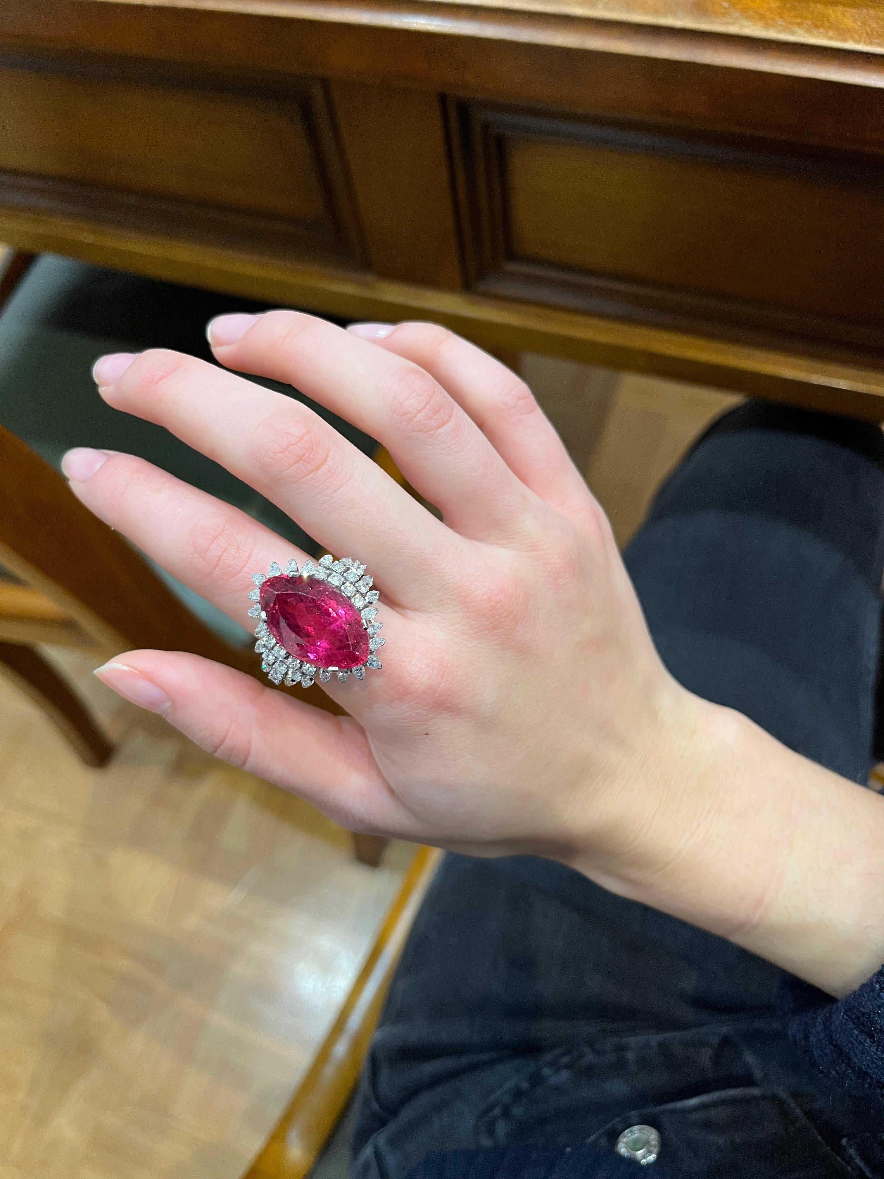 A marquise cut Rubellite of 18.71 ct set with 2.75 ct of diamonds in Platinum. The rubellite has eye visible inclusions but the colour is beautiful and intense. The rubellite has abrasions along its facets. 