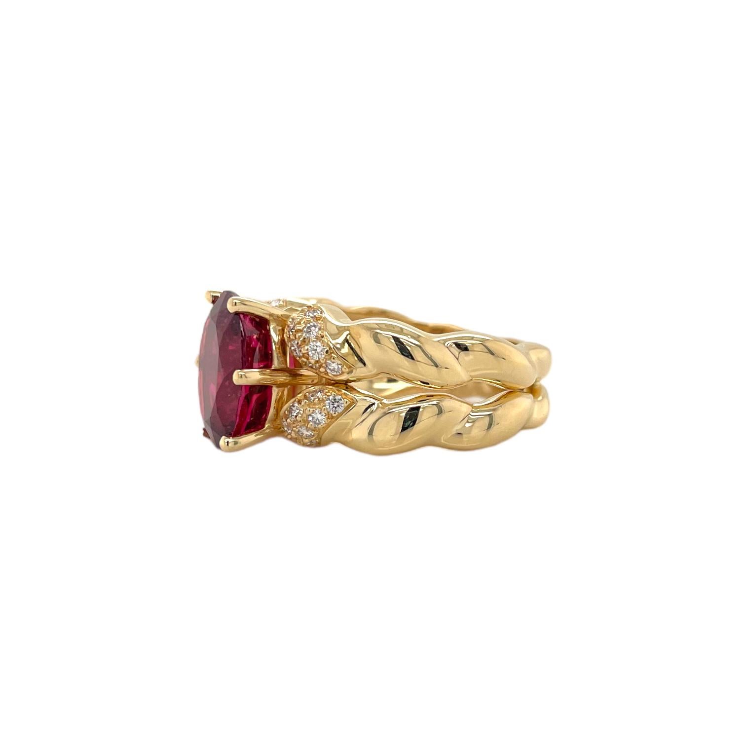 Ring contains one center oval brilliant rubellite tourmaline, approximately 4.83cts. Center stone is accented by 32 round brilliant diamonds on the shoulders, approximately 0.35tcw.  Diamonds are near colorless and SI1 in clarity. Width of ring