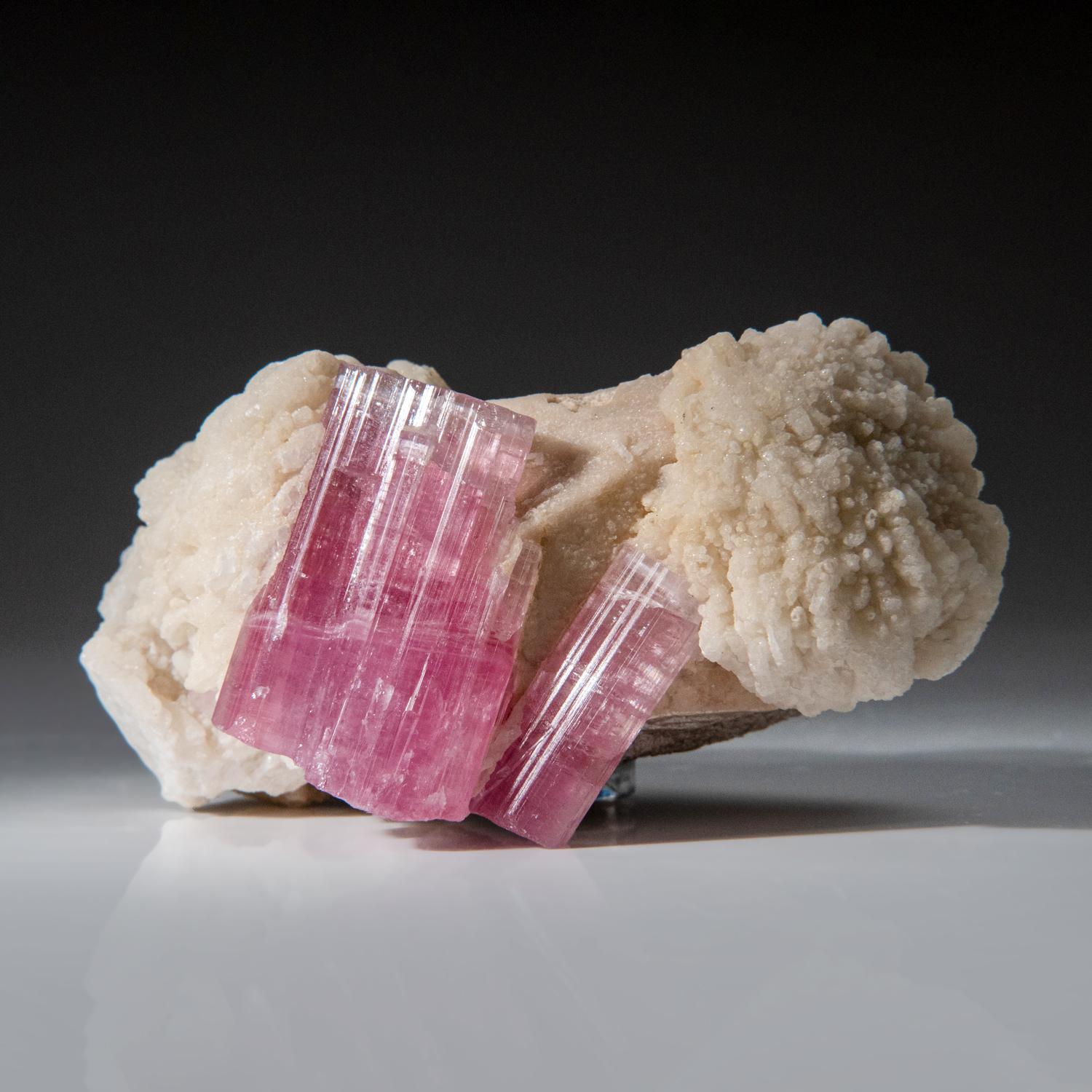 from Paprok, Kamdesh District, Nuristan Province, Afghanistan

Superb specimen of lustrous Rubellite var. pink tourmaline crystals fully terminated in a parallel formation embedded on Albite microline matrix. The tourmaline crystals have rich