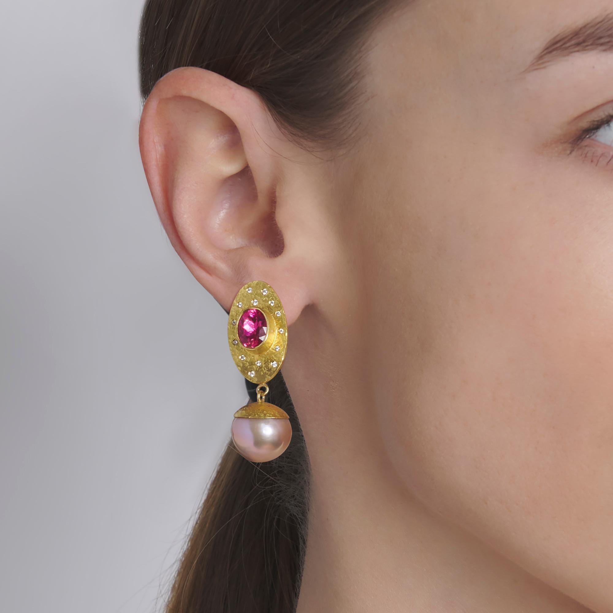 These exquisite earrings won the 2017 Niche Award for Fine Jewelry.

Beautiful, bright and very clean, oval shaped rubellite tourmalines (2.16 carats) are wrapped in bezels of 22 karat yellow gold.  The rubellite tourmalines sit on large ovals of