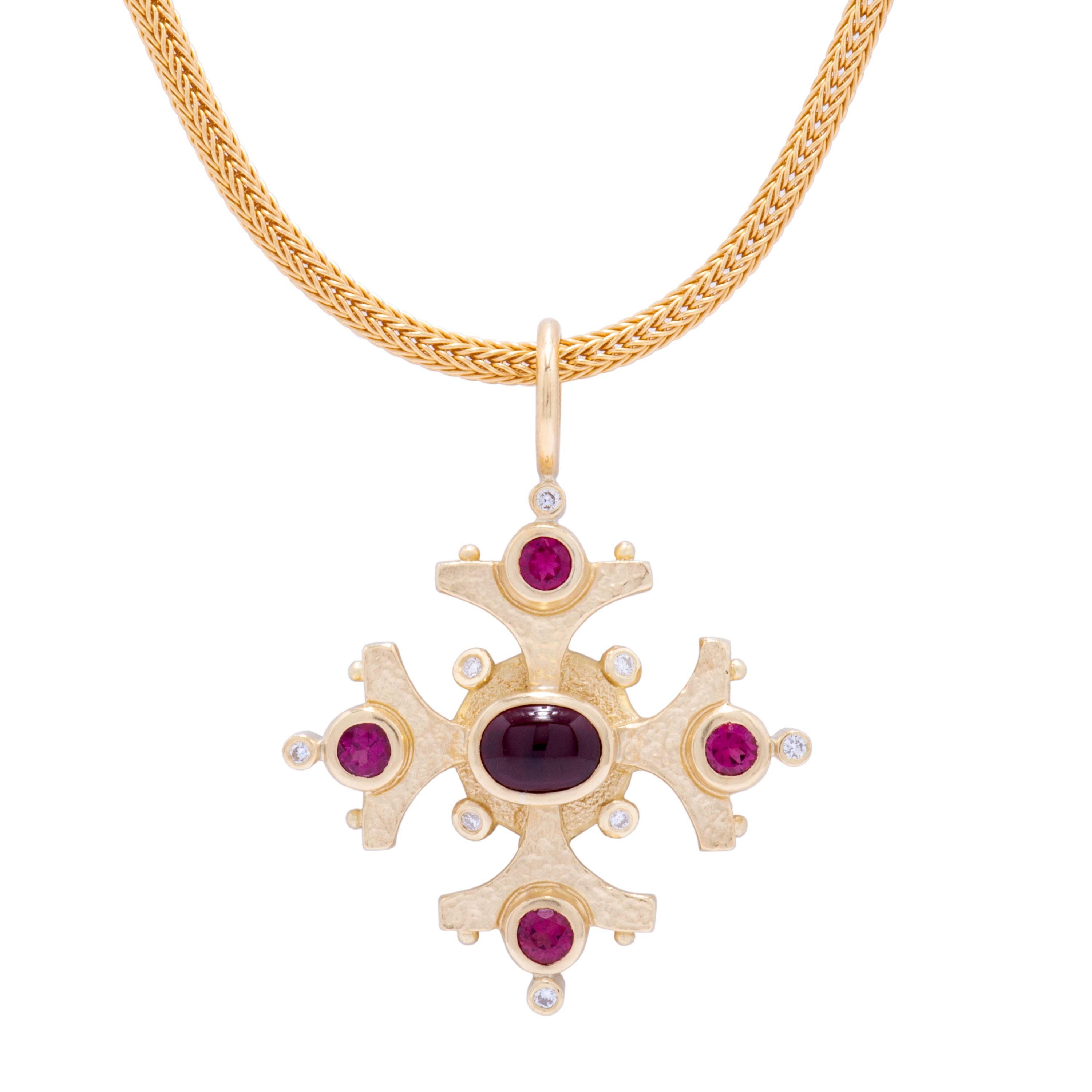 Our 18k gold Maltese Cross pendant turns palatial, fitted with a 2.16ct rubellite tourmaline cabochon, luscious faceted rubellite 1.08tcw, and .20cts twinkling diamonds. At 2