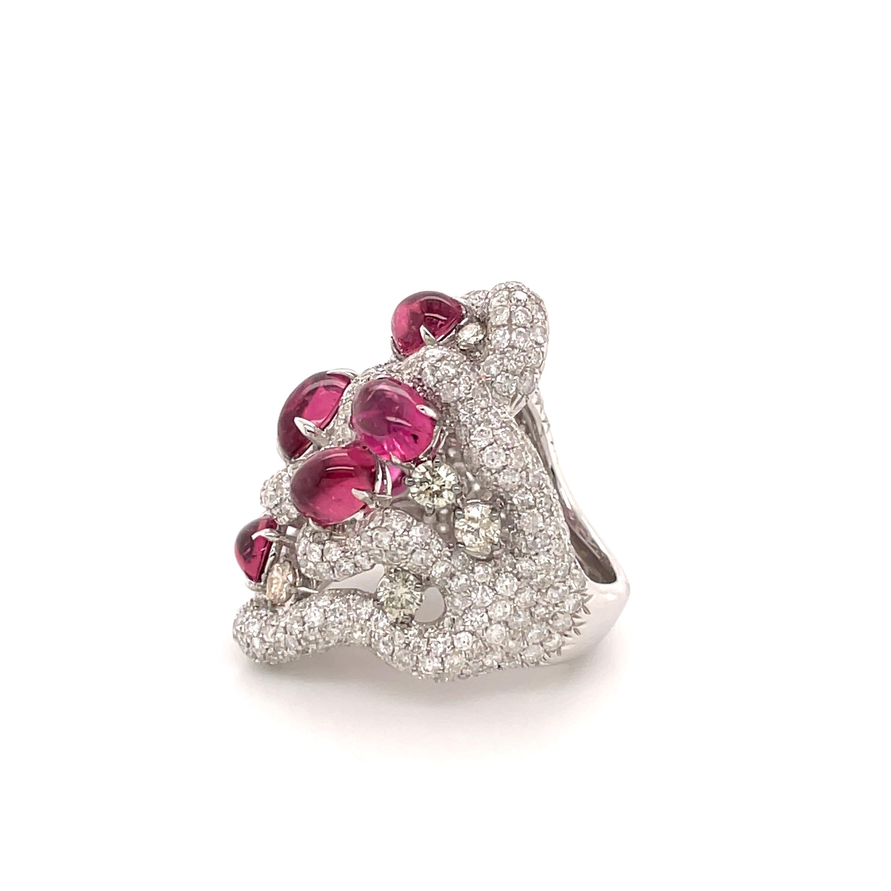 The Rubellites Entangled Diamond Multi Rope Ring is a striking work of art that seamlessly combines elegance with a touch of avant-garde design. At the heart of the ring, a lustrous rubellite gemstone takes centre stage, radiating a deep and