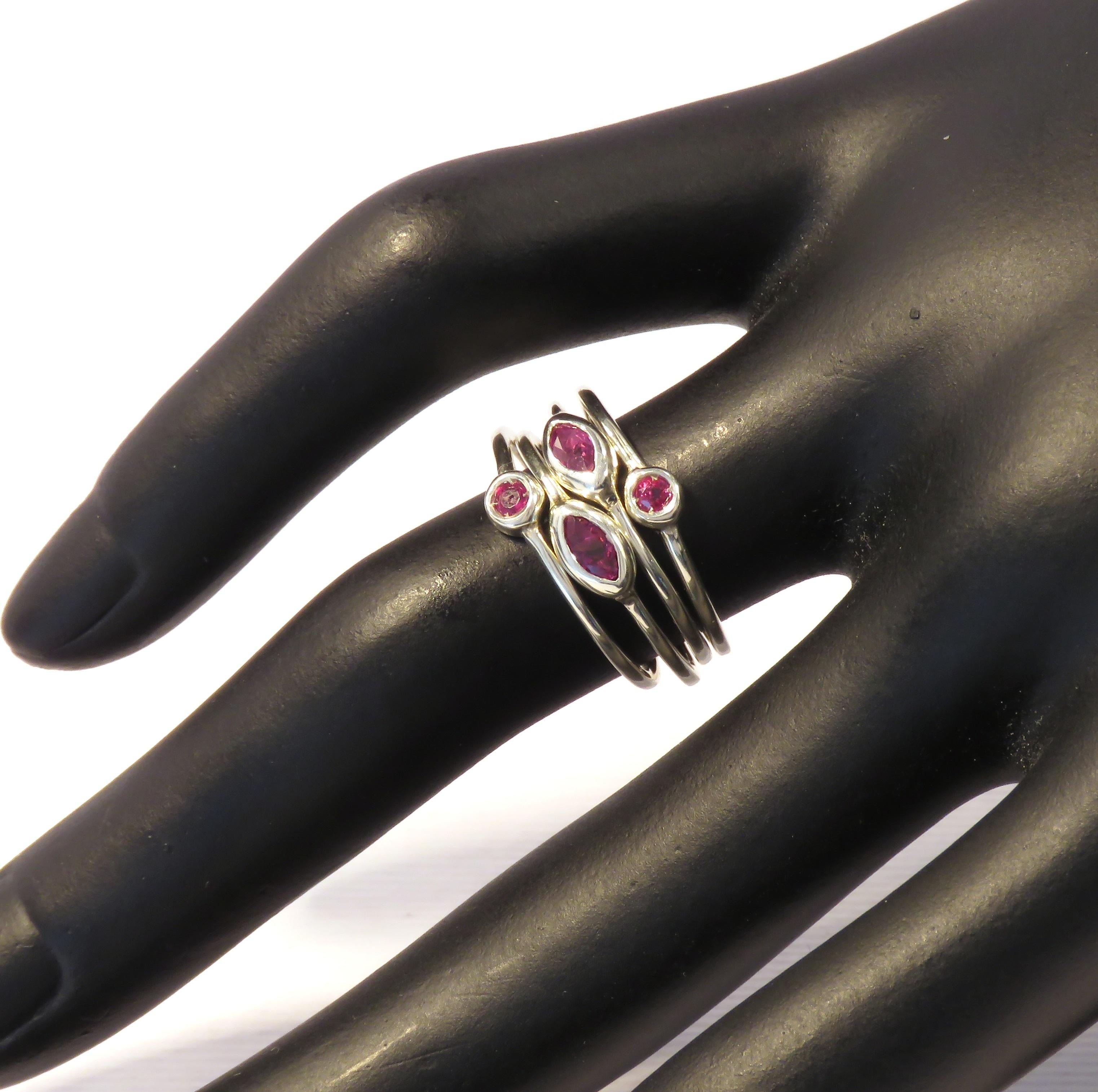 Modern stacking rings in 9 karat white gold with natural navette cut and brilliant cut rubies. The price of this item is for four stacking rings and it is composed by four rings with 2 rubies brilliant cut and 2 rubies navette cut. US finger size is