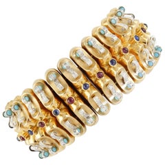 Bracelet jonc en or jaune, rubis, saphirs bleus, turquoises et diamants
