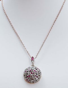 Rubies, Diamonds, 14 Karat Rose Gold and Silver Pendant.