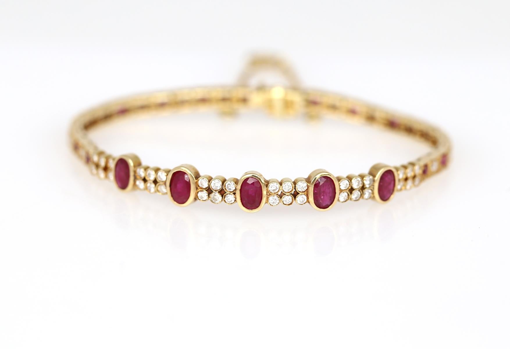 Modern Yellow Gold Bracelet with five fine oval-shaped Rubies and round-cut Diamonds. The Yellow Gold is a fine contrast to the fine Red Rubies on the face side. The construction of the bracelet is really flexible and tender. It sits perfectly on