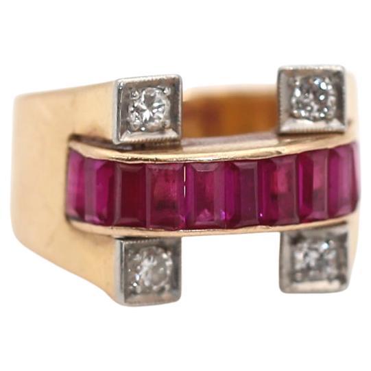 The shape of a horseshoe is a long-standing tradition of a Luck charm. It is believed to bring good fortune. A ribbon of deep red baguette-cut Ruby stones creates a fine line finishing the horseshoe composition. Four fine round-cut Diamonds are set