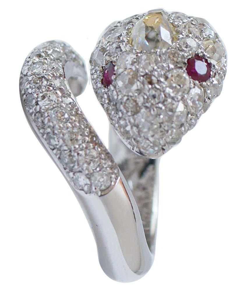 Fashion snake ring in 18 kt white gold structure  mounted with diamonds for all the body and three fancy old-cut  diamonds on snake head. As eyes, two rubies.
This ring was totally handmade by Italian master goldsmiths and it is in perfect