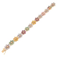 Manschettenarmband mit Rubinen, Smaragden, Saphiren und Diamanten aus 14 Karat Gelbgold