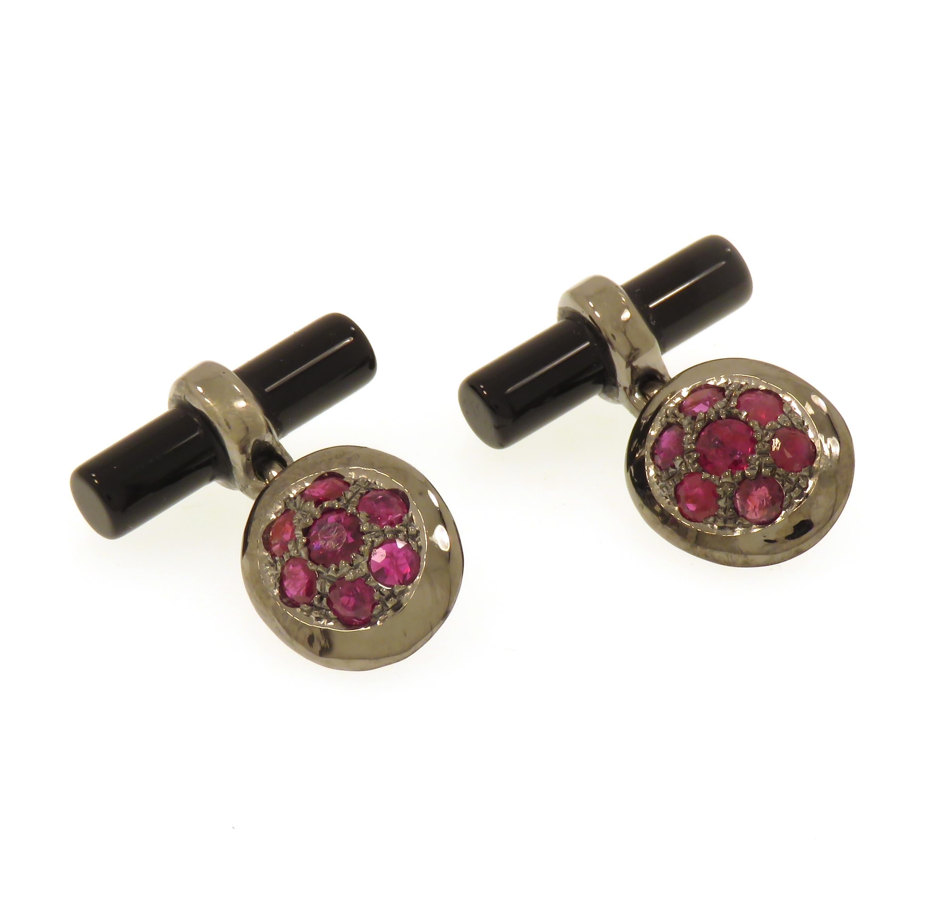 Elegant cufflinks crafted in 9 karat white gold black rhodium plating featuring 14 natural round cut rubies and two natural onyx bars. Oval front dimension is : 15x12 mm / 0.590x0.472 inches, back bar dimension is; 20x5 mm / 0.787x0.196 inches.