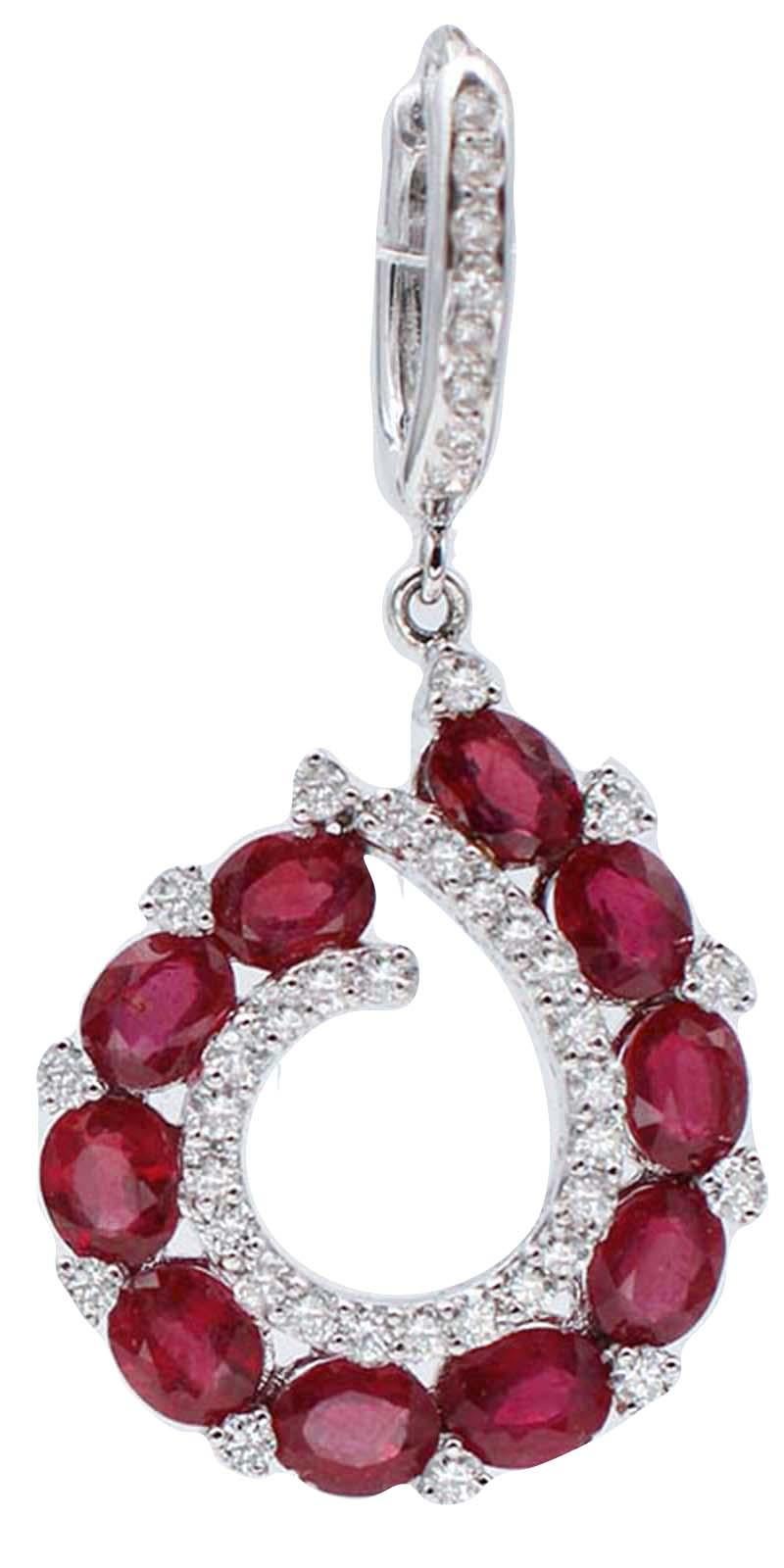 Amazing earrings in 18 karat white gold structure mounted with a round of rubies surrounded, internally and externally, with white diamonds. On the clasp, a row of 8 diamonds.
Diamonds 1.78 ct
Rubies 11.76 ct
Total Weight 11.90 gr
RF  +IUIH

For any