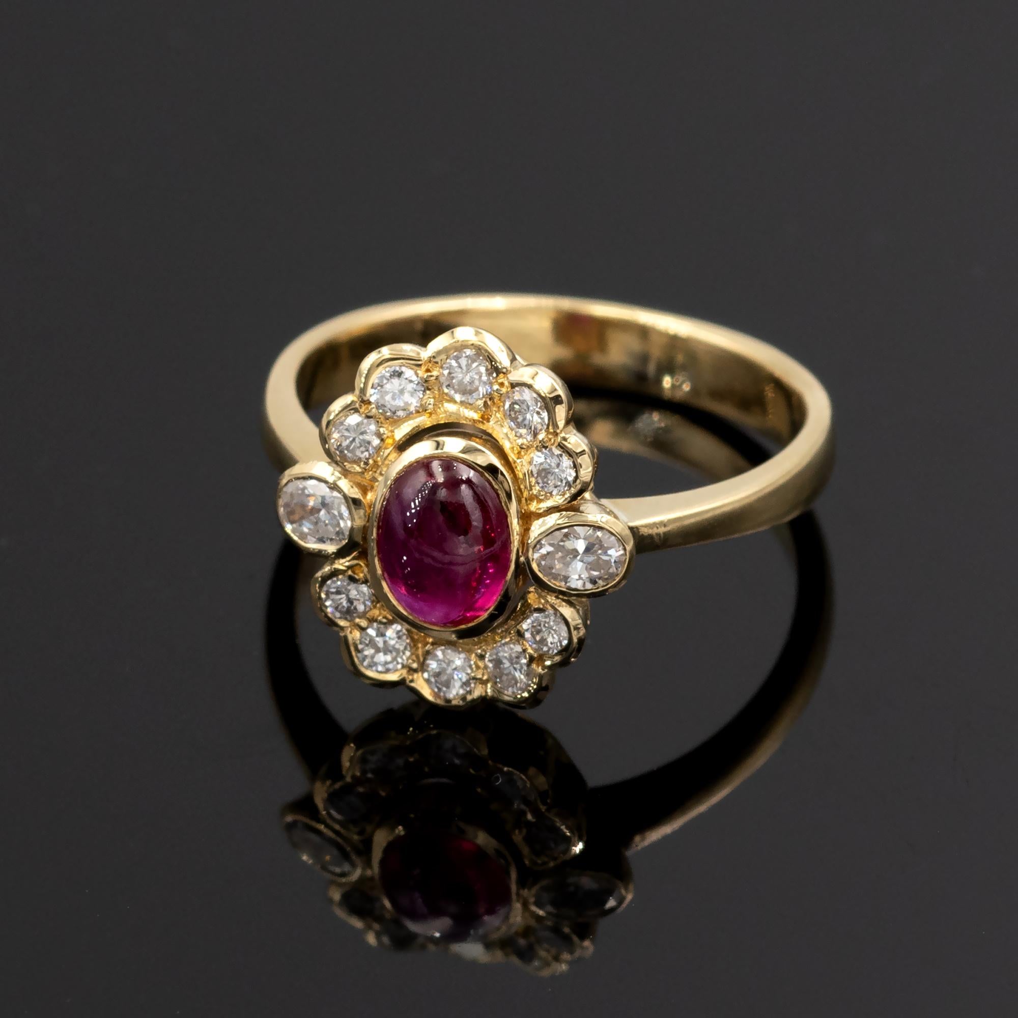Graceful flower like halo ring showcasing a lively cabochon ruby surrounded by oval and round brilliant cut diamonds ( approx 0.4ct FG VS). The ring is in plain 18 karat yellow gold.
the head is 12.7 x 11.8 mm