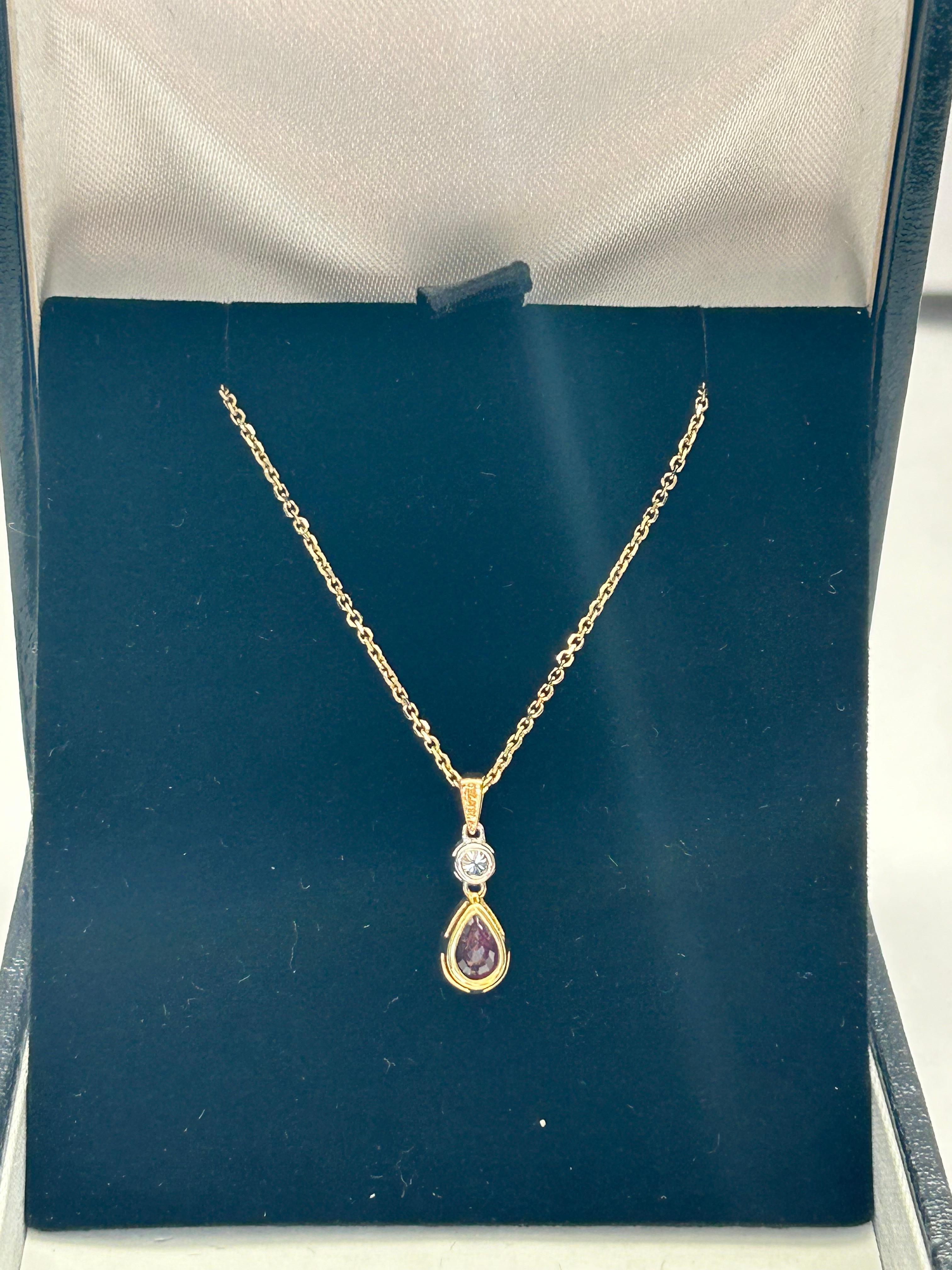 This pretty ruby and diamond pendant is set in 18ct white and yellow gold.  The pendant drop measures 10mm, Ruby est 0.53ct and diamonds est 0.06ct.  The chain on this pendant is 16