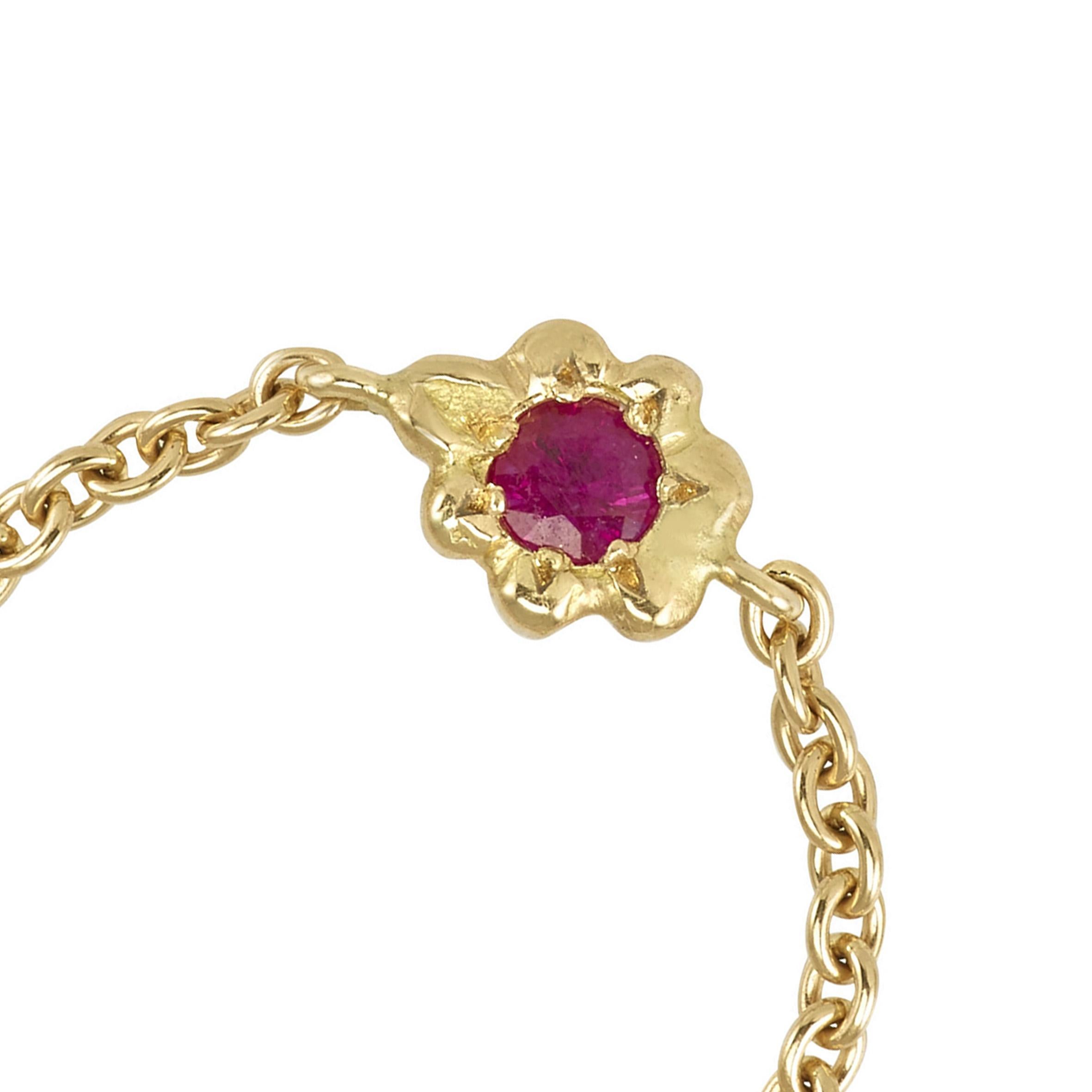 This Anais Rheiner ring is handmade in 18 Karat Yellow Gold. It is set with a ruby, approximately 0.3 carats. The ring band is a chain that is moveable in order for it to position itself nicely on the finger for real comfort. Its weight is 1 gram