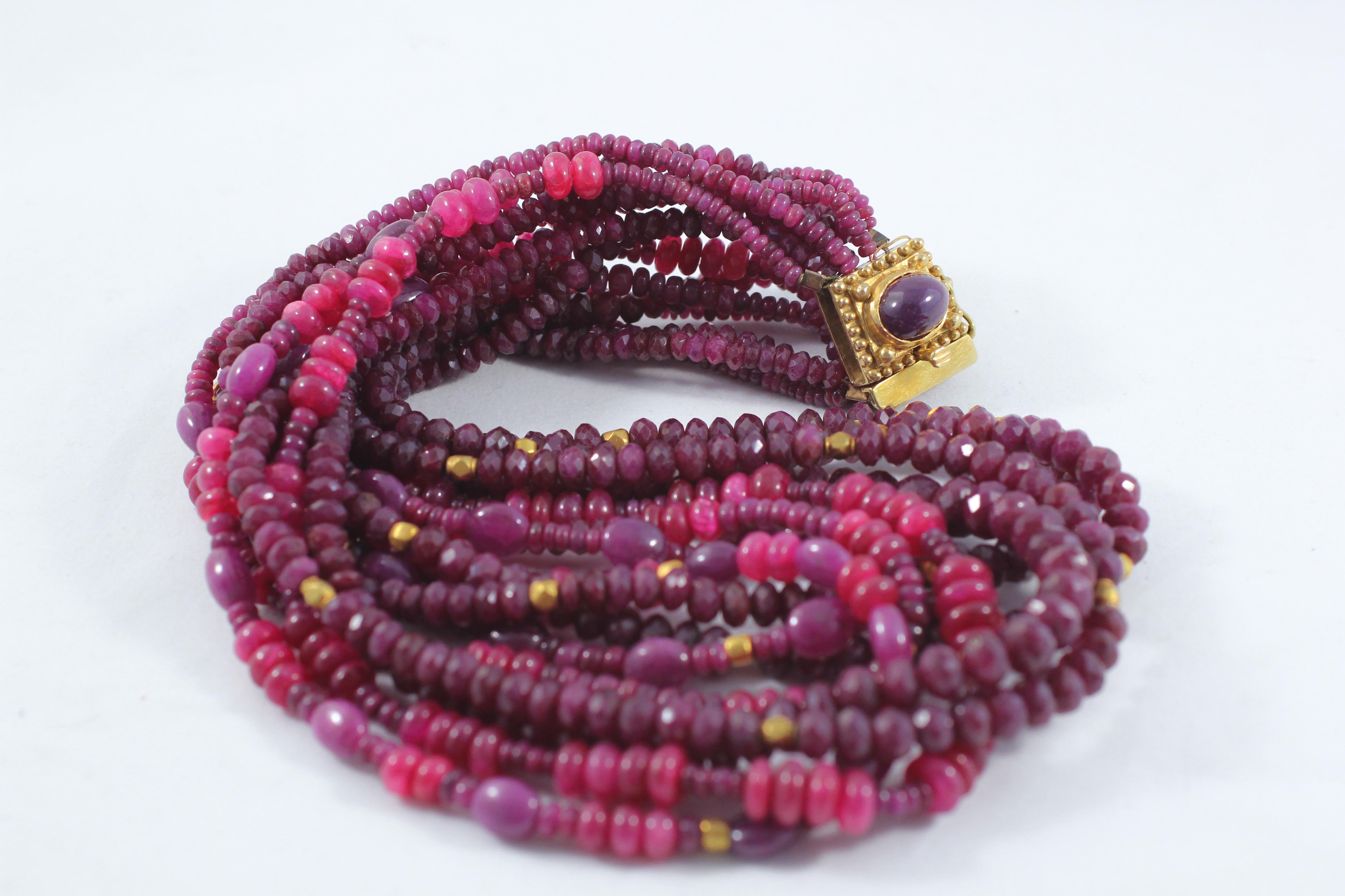 The ruby and 18K gold beaded handmade choker necklace. Nicely faceted ruby beads are sparsely speckled by round bead spacers in recycled 18k gold. A handmade clasp with a bezel set ruby terminates this beautiful luscious necklace and adds drama and