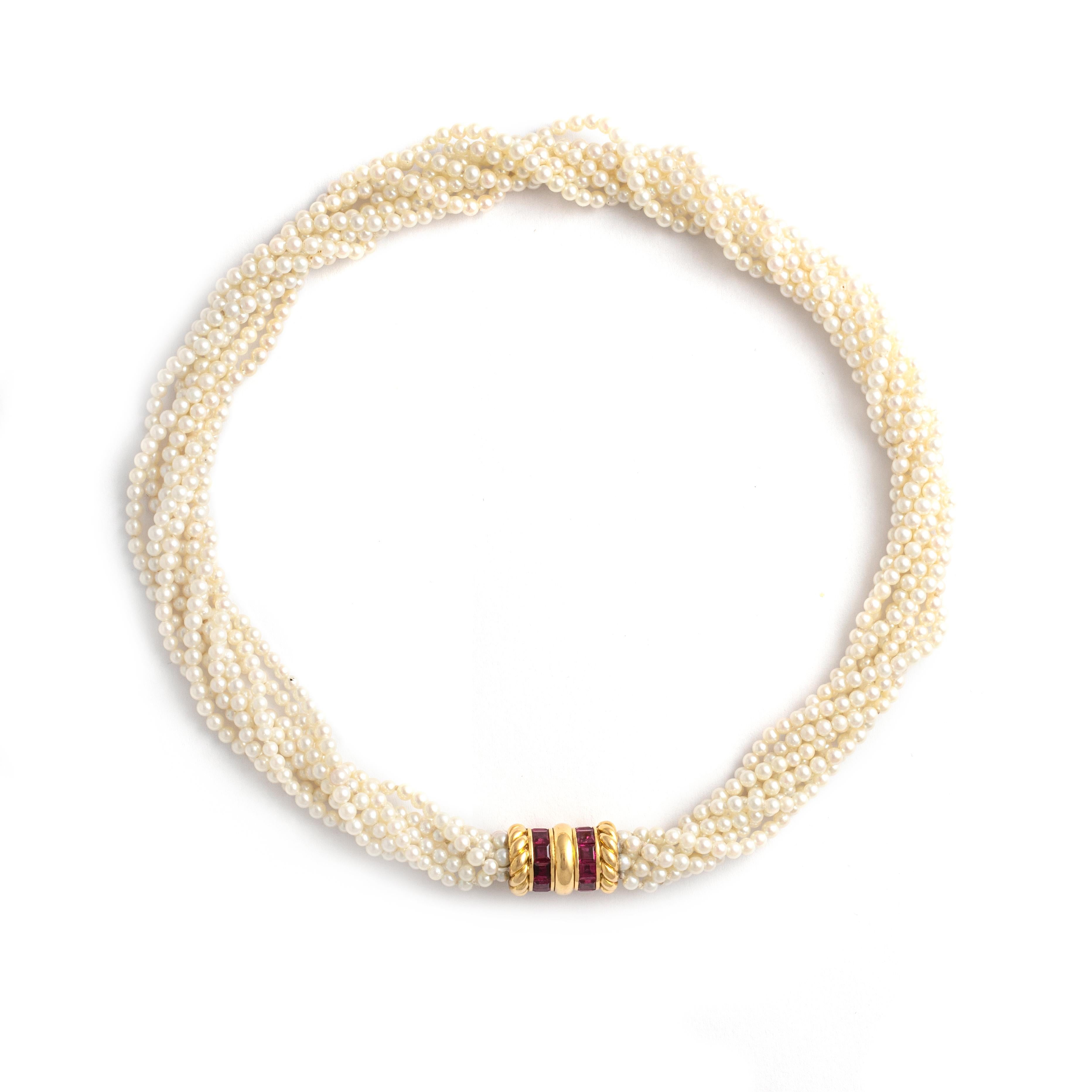 Immerse yourself in the luxurious fusion of timeless elegance and vibrant allure with this Ruby 18K Yellow Gold Pearl Necklace. Crafted with meticulous attention to detail, this statement piece features six strands of cultured pearls, each strand