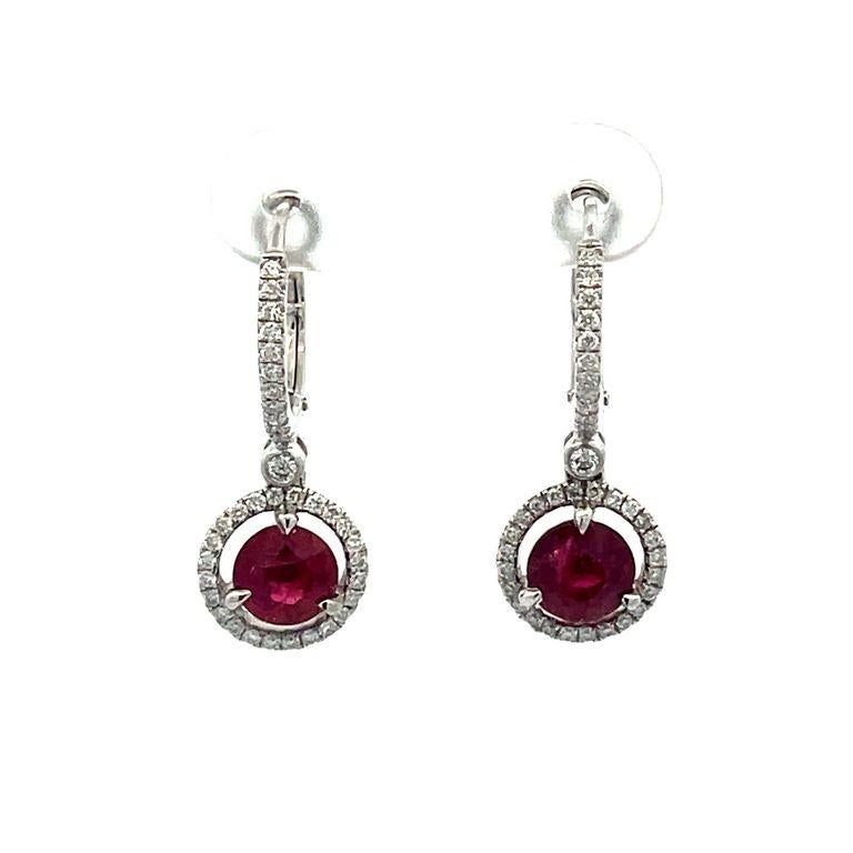 Elevate your style with these exquisite diamond earrings that display elegance and sophistication. Each earring features a high-quality GIA-certified red ruby in the center in 2.36 carats weight, also a stunning display of luxurious round white