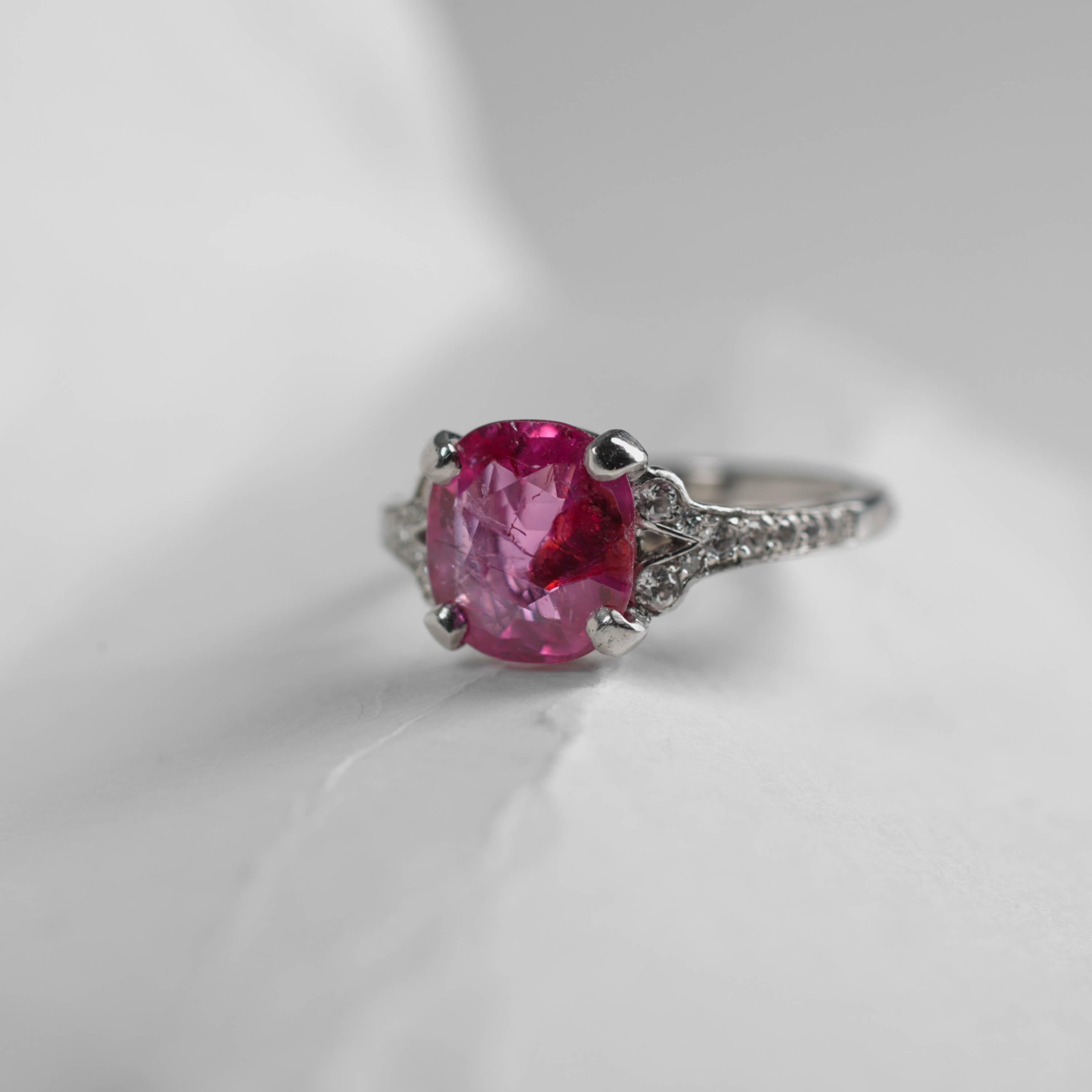 A spectacular -and exceedingly rare- certified natural and unheated Burmese ruby weighing just over three carats shines like a beacon from within the four-prong French mounting. Rubies over one carat are rare, and Burmese rubies are the standard