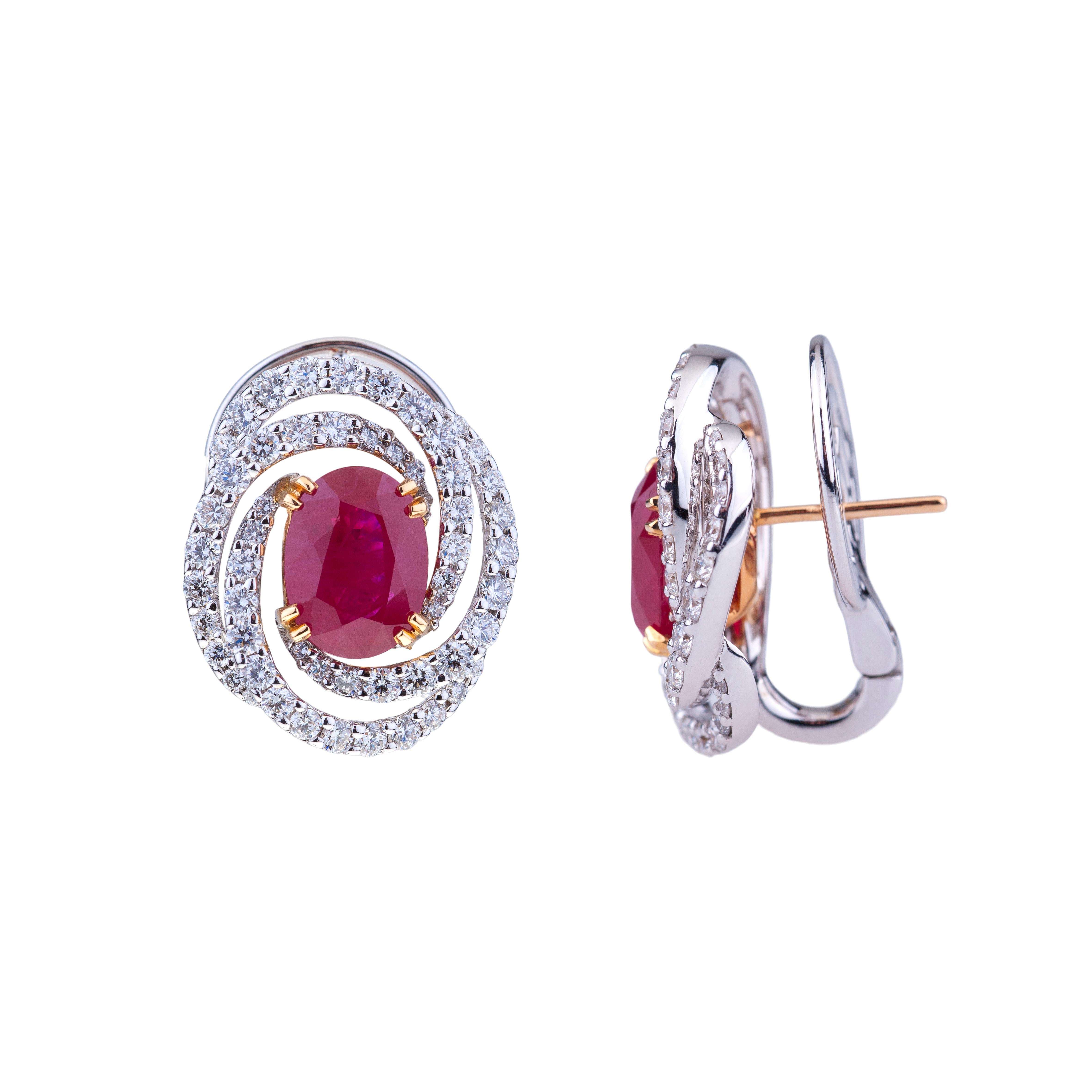 Ruby 3 ct. Each Earrings White Gold with Circle of Diamonds, with Certificate.
Contemporary Design for this Earrings with a Pair of Stunning Intense Red Ruby:
ct. 3.04 size 9.33X7.21X5.29 (cert. n. 17110689) + ct. 3.01 size 9.66X7.26X4.84 (cert n.