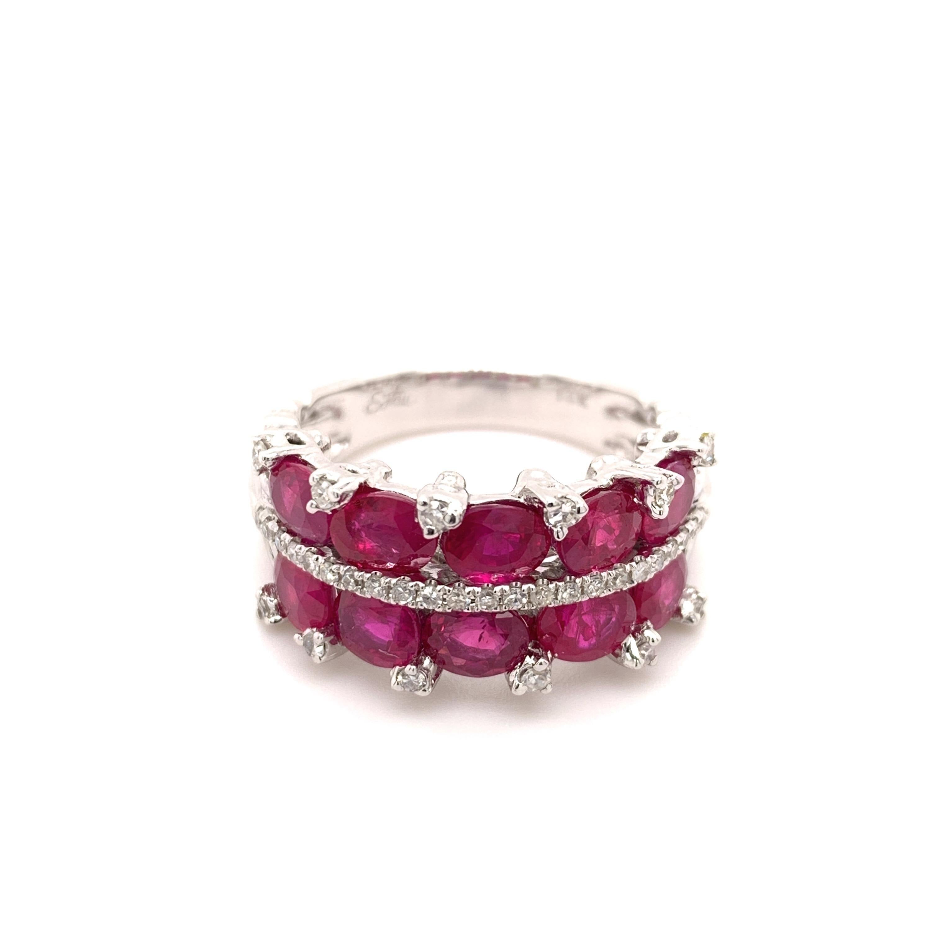 Beautiful ruby diamond ring. Pinkish red, oval faceted rubies mounted in two rows, dividing with round brilliant cut diamond row. Beautiful handcrafted high polished design set in 14 karat white gold  tapered band. 

Ruby: 3.5 carats, oval faceted,