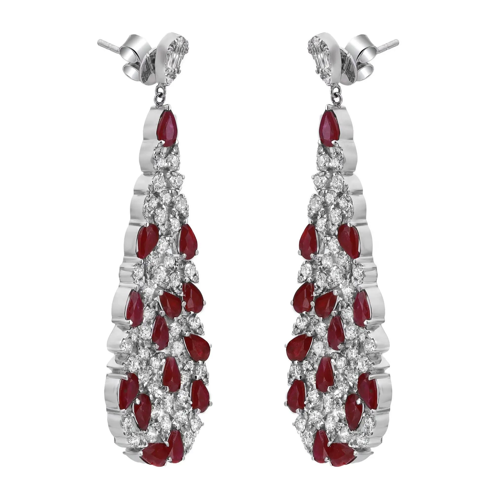 Shimmering ruby and diamonds sway along these stunning 14K white gold women's drop earrings. These earrings feature prong set pear cut rubies and round brilliant cut diamonds encrusted in a pear shaped mounting hanging from a small pear shape stud