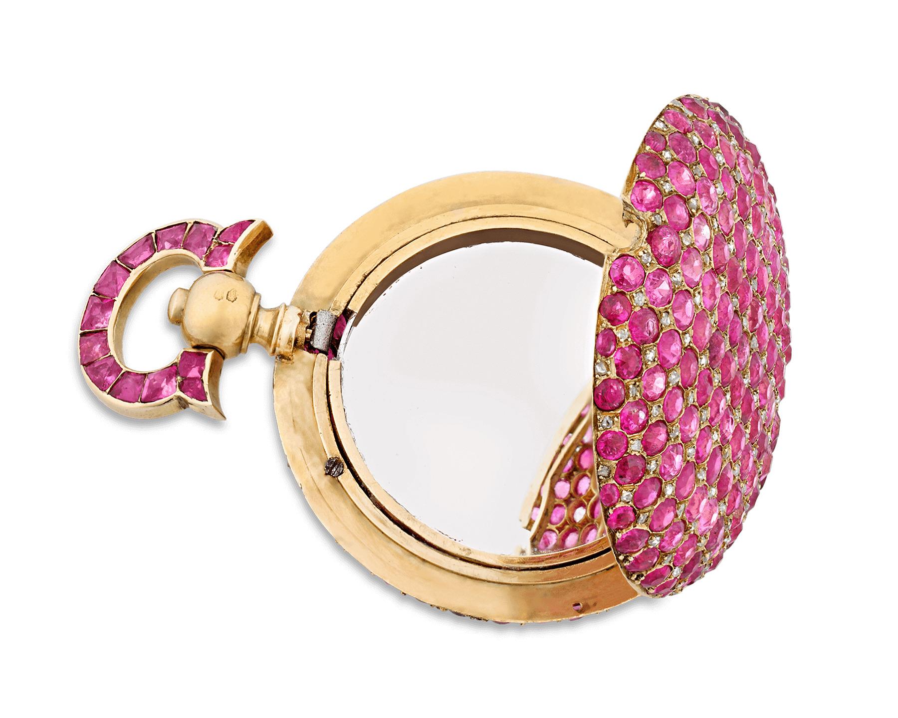 This delicate-yet-stunning locket is adorned by approximately 240 dazzling red ruby cabochons. Crafted of 14K yellow gold, the gorgeous rubies encrusting this locket weigh approximately 7.00 carats total. Open up this surprising pendant to reveal a