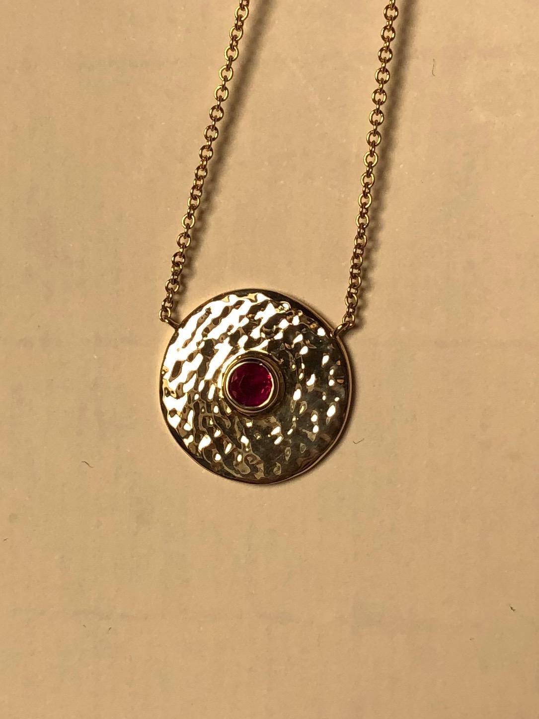 A bright Gemfields Mozambique ruby is is nestled in a hand hammered disc of 18 karat gold. Centering, a pendant to wear every day and perhaps never take off. 



Mozambique ruby- 3 mm from Gemfields.
18 karat 100% recycled gold.
Made by Hand in